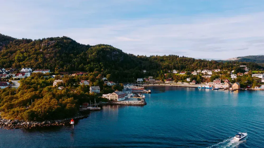 A boat sailing into a picturesque bay in Stavanger in Norway