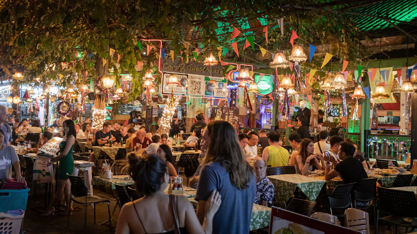 A busy outdoor restaurant filled with diners