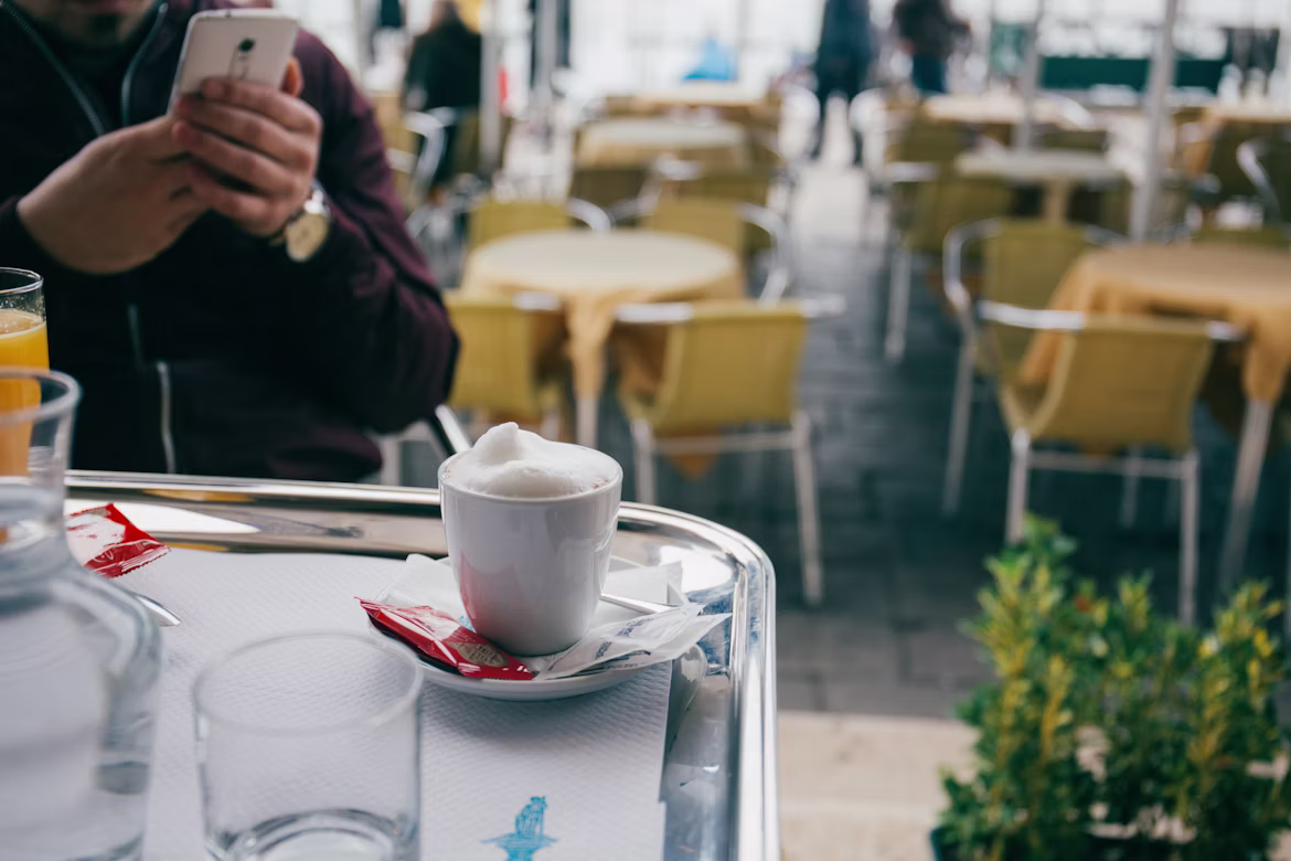 A foamy cup of coffee at a quiet cafe in Venice