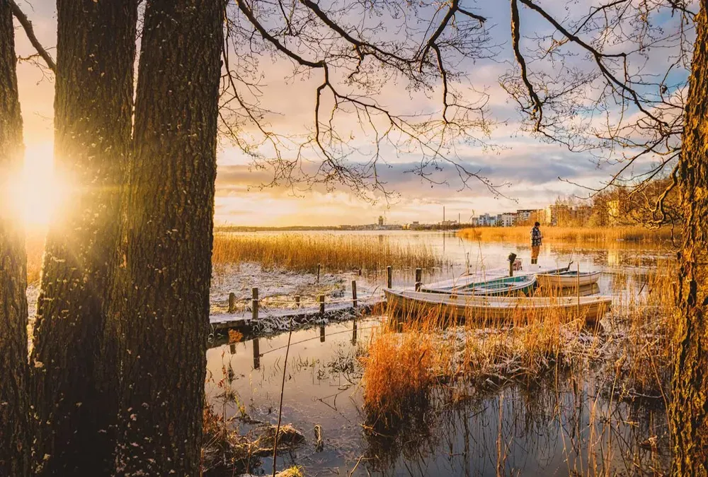 A man standing on a frosted jetty at sunrise in Helsinki