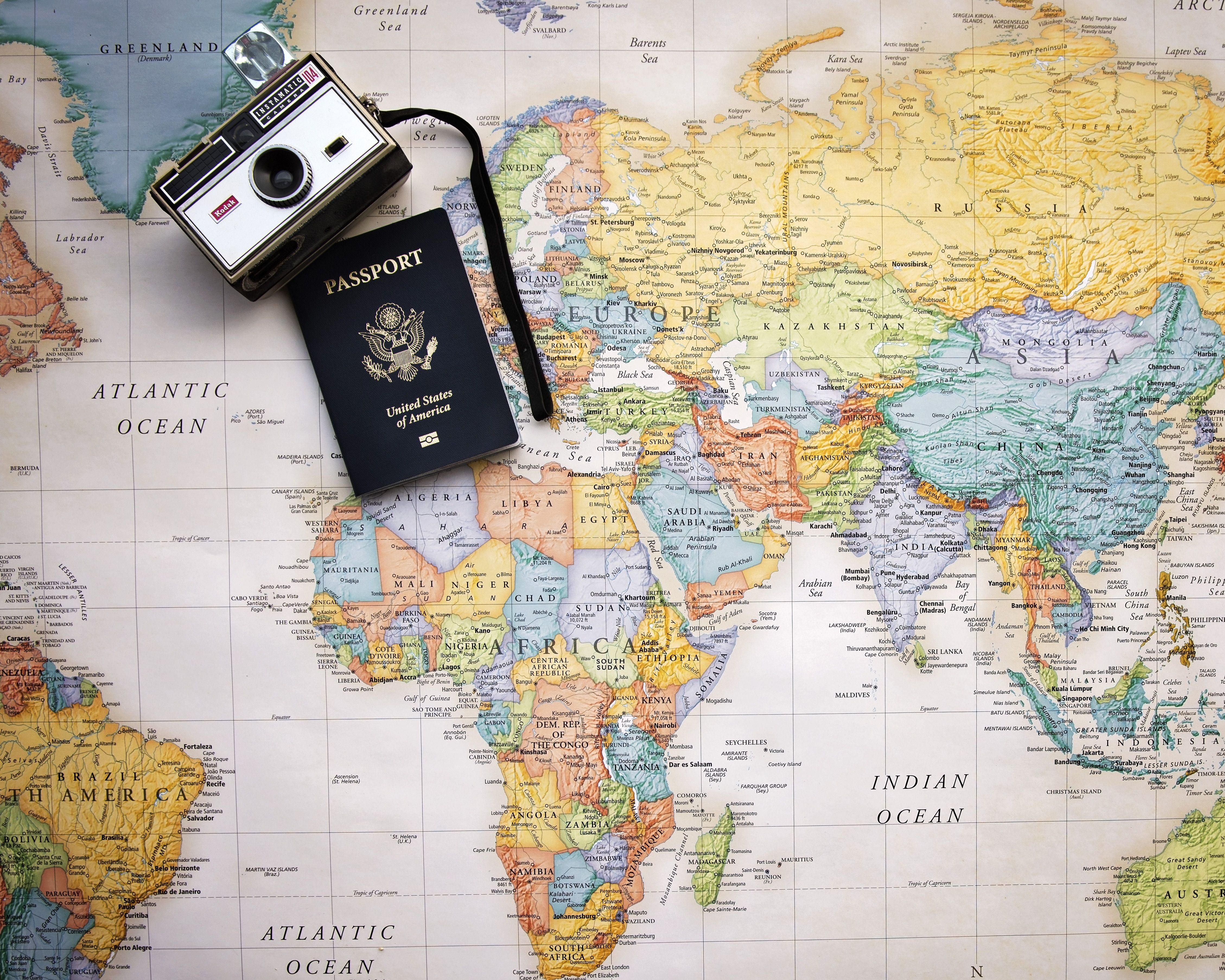 passport and camera on a map of the world