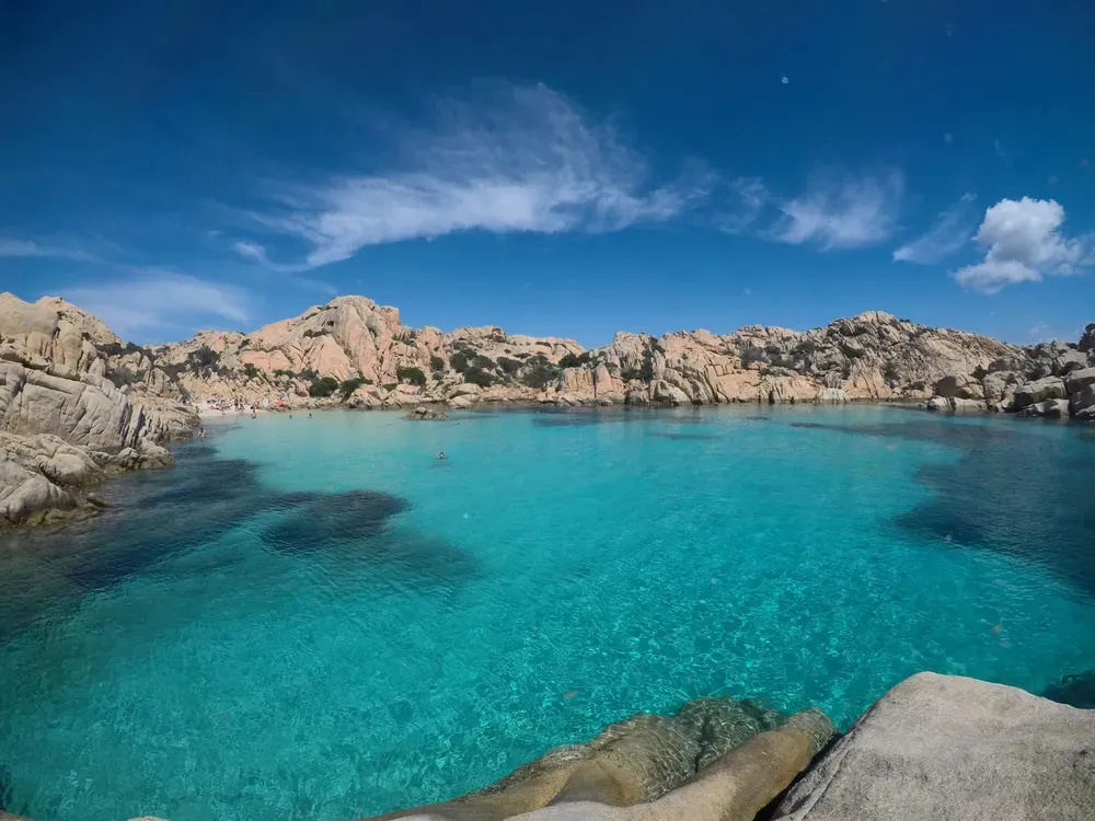 bay with clear waters surrounded by cliffs