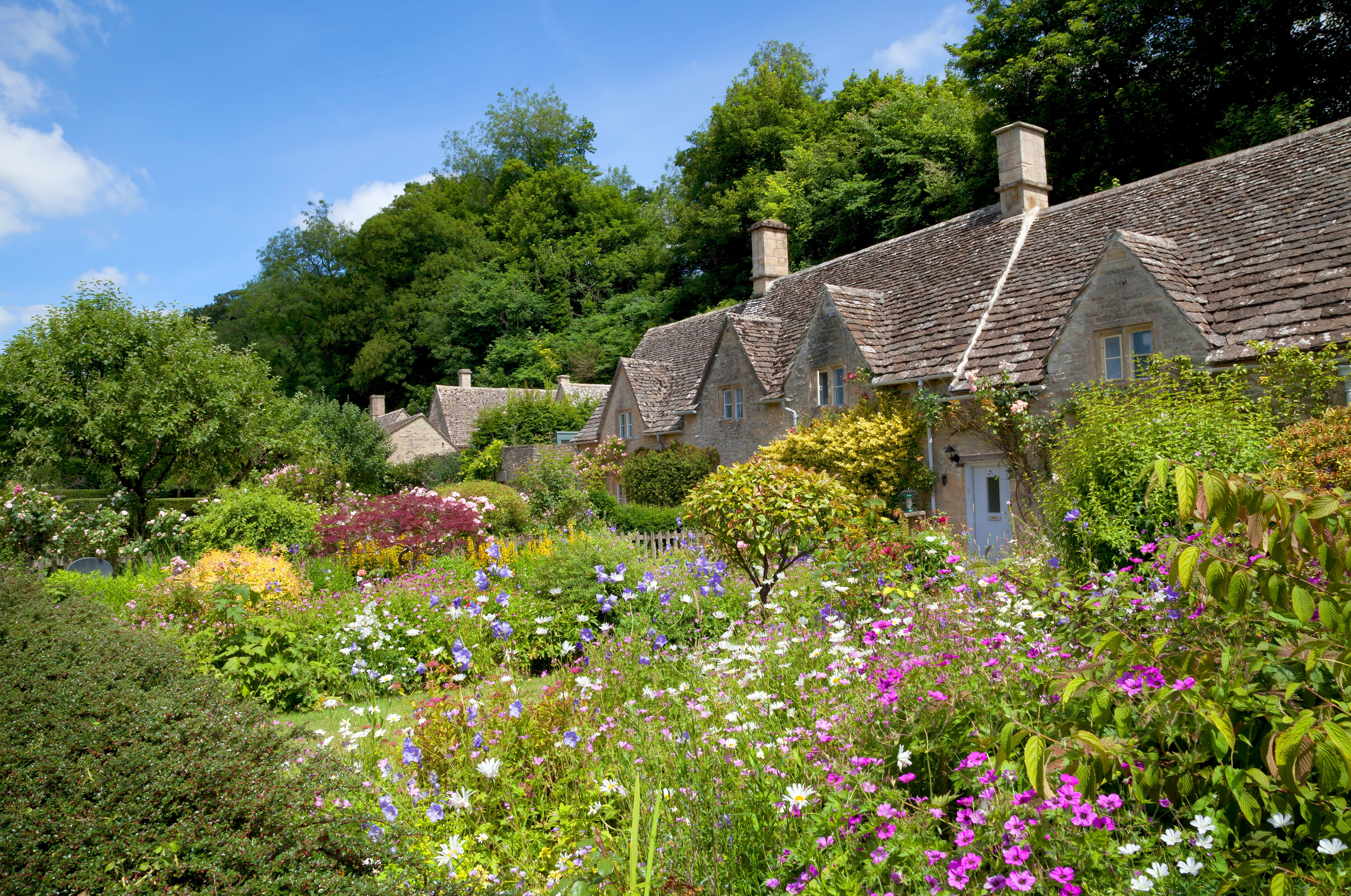 flowers next to cottages in Bibury