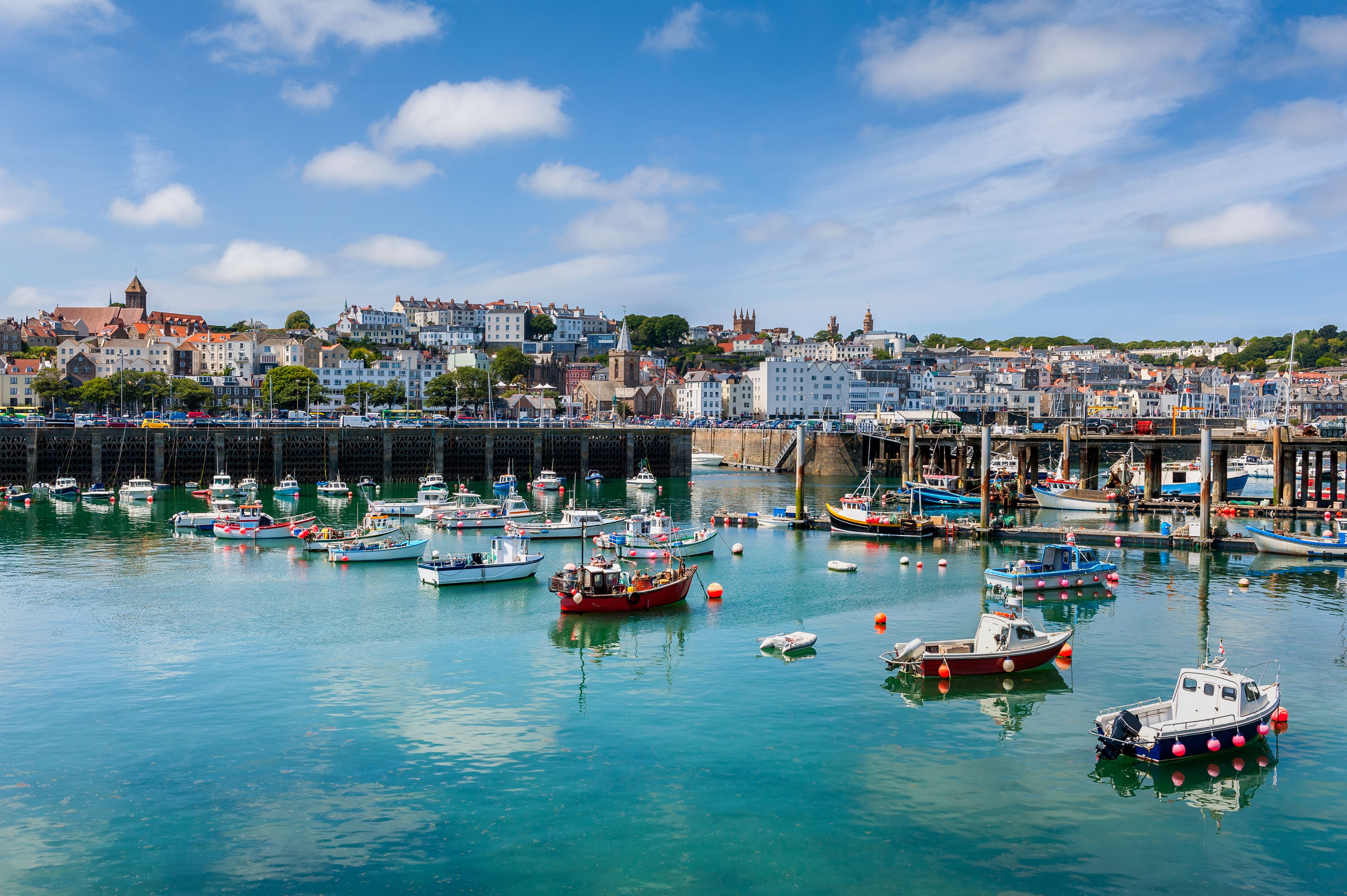 boats docked by the town of St Peter Port