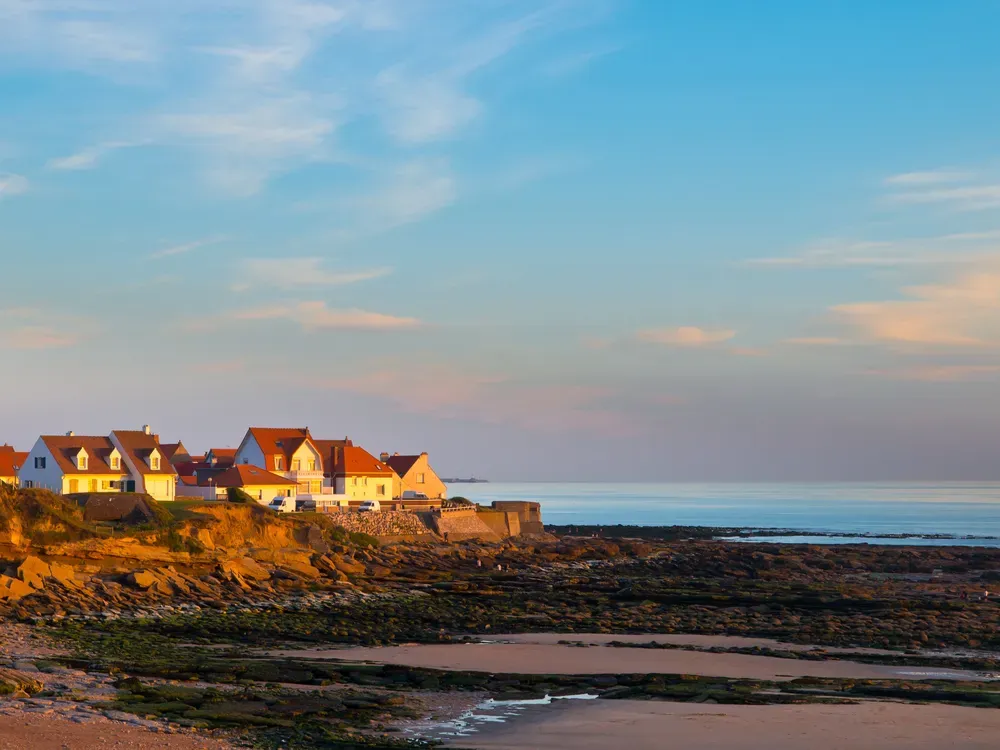 Houses perched on the rocks on the beach in Calais