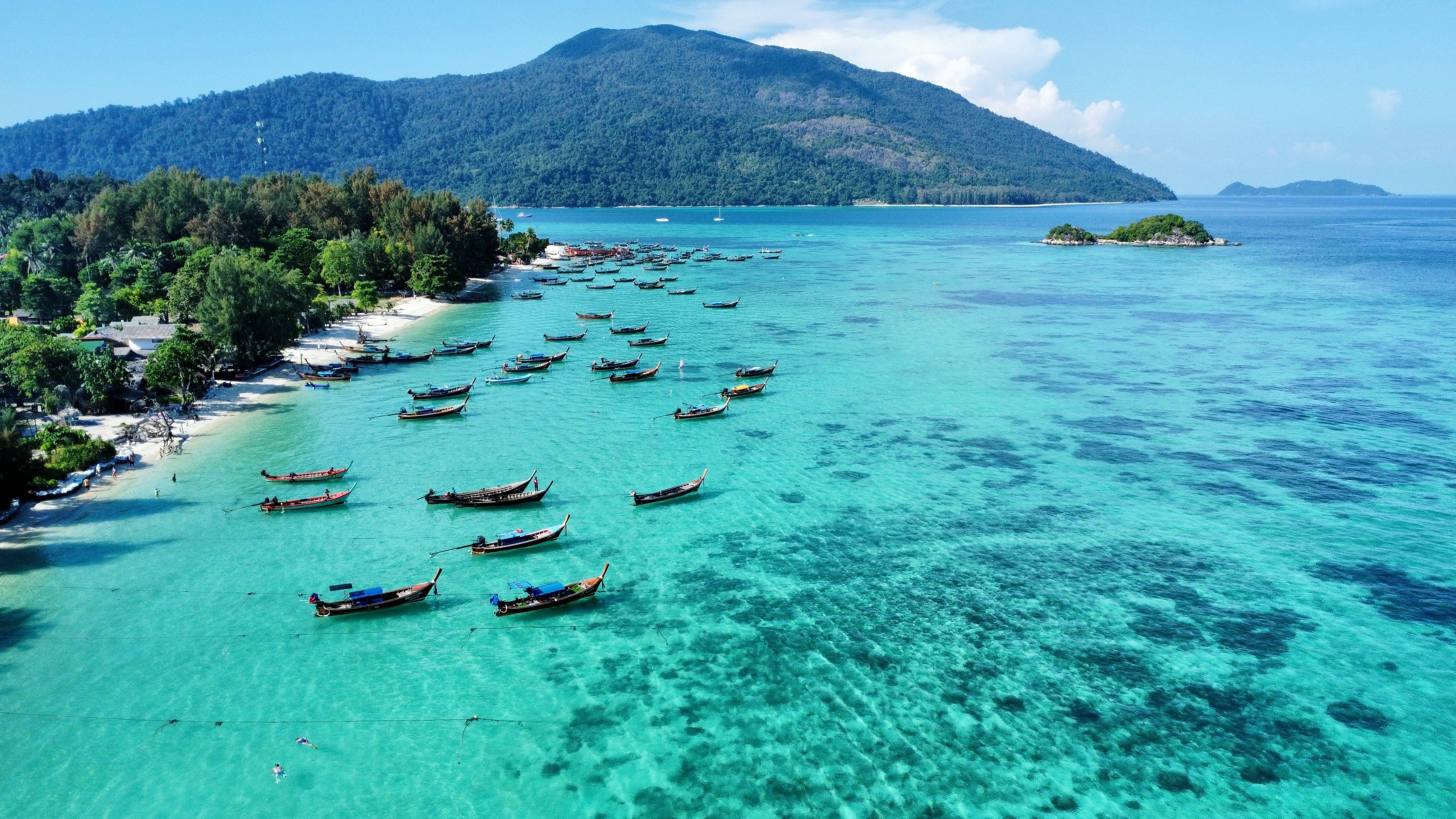 longtail boats on the coastline of Koh Lipe