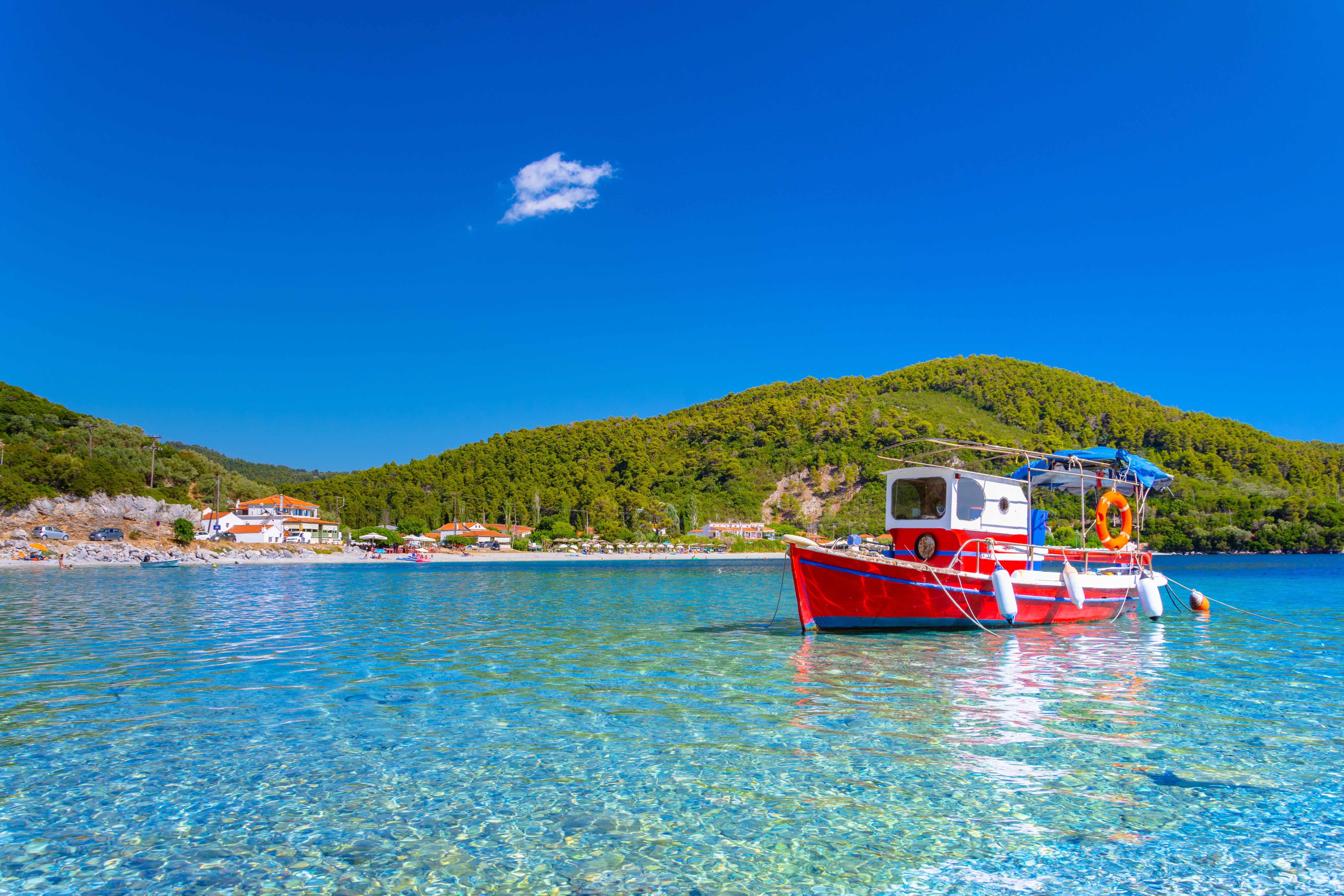 boat in the water in Panormos beach in Skopelos