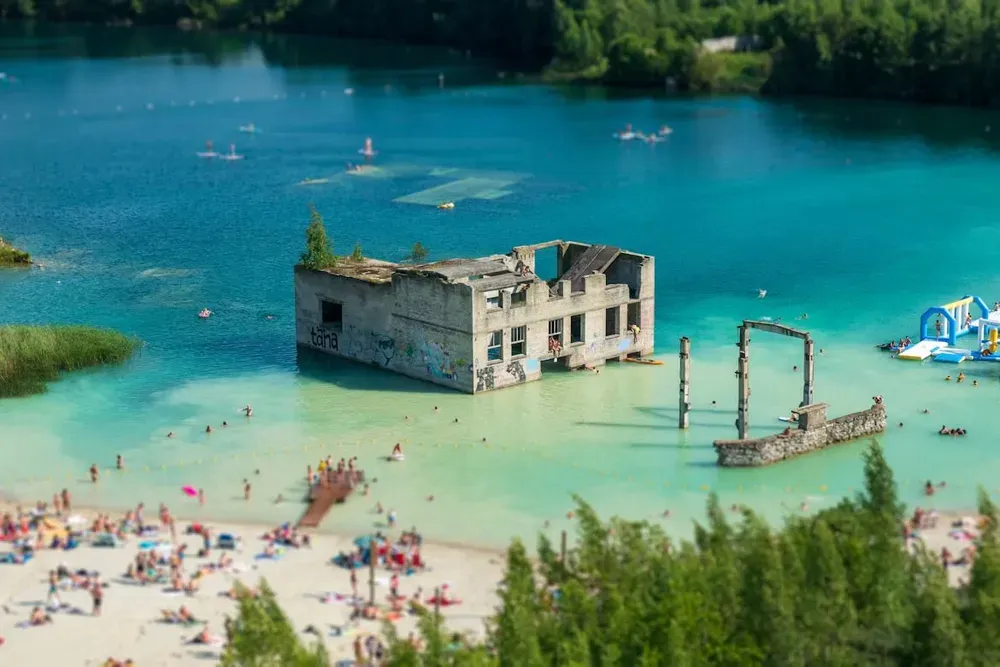 People swimming in Rummu Quarry and Underwater Prison