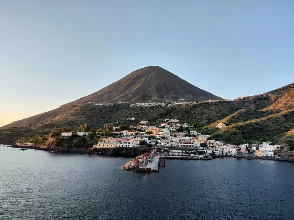 village at the bottom of the mountains next to the sea