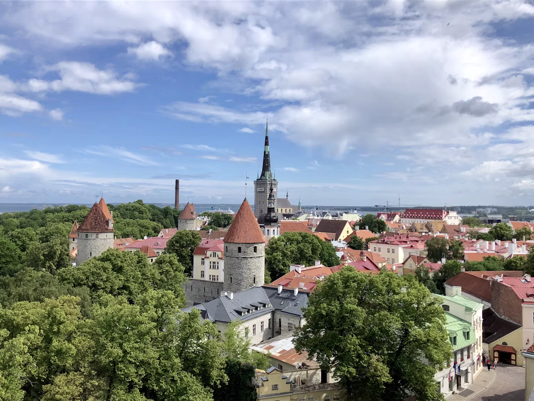 An ariel view of Tallinn Old Town with the church spire rising high into the clouds