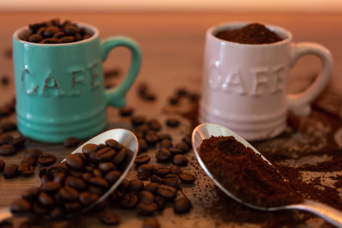 Two cups filled with coffee beans