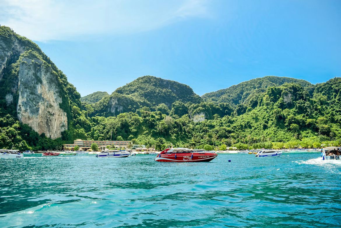 a red speedboat docked near a beach in the Phi Phi islands.jpg