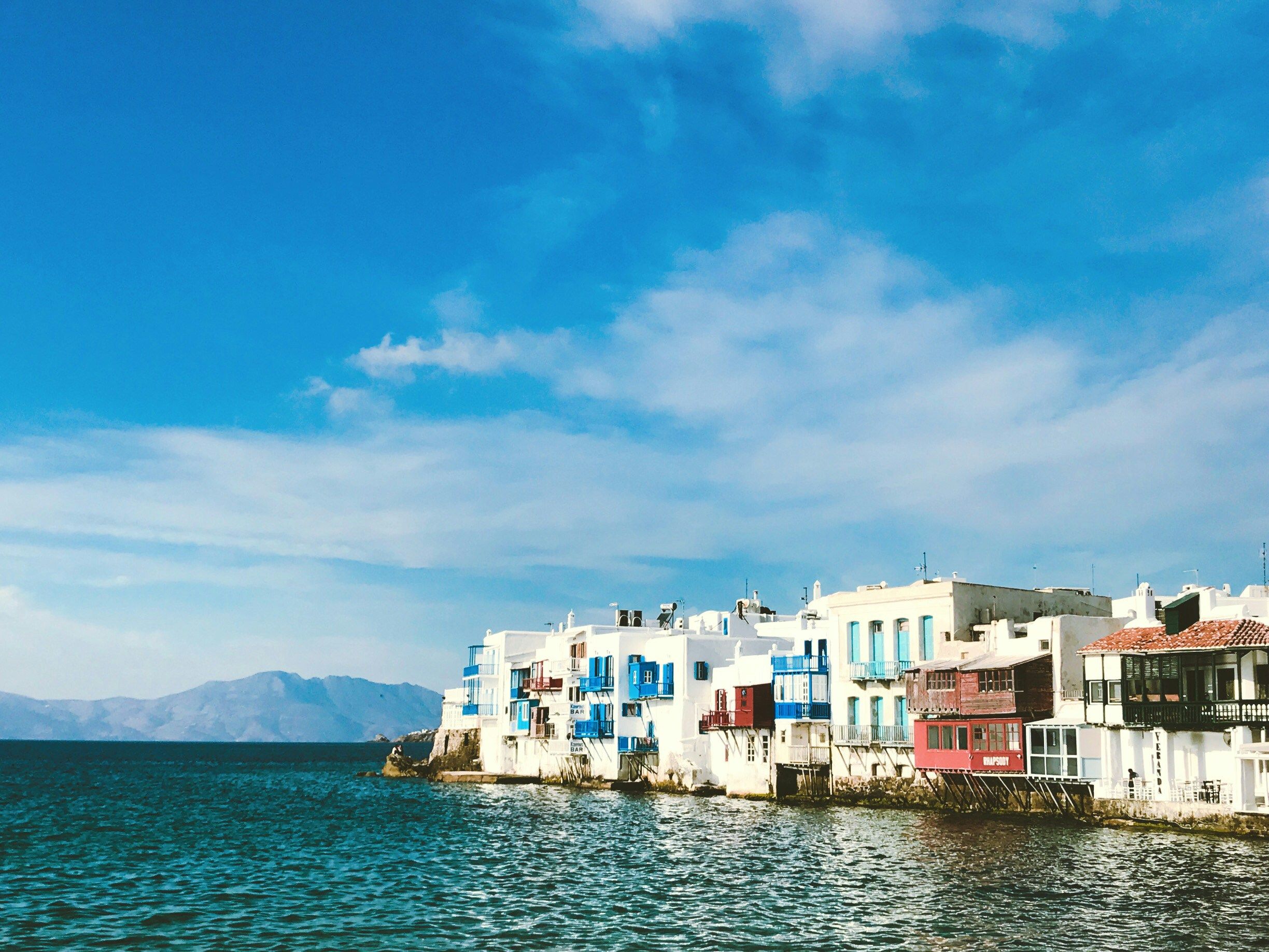 blue and white buildings by the sea in Mykonos