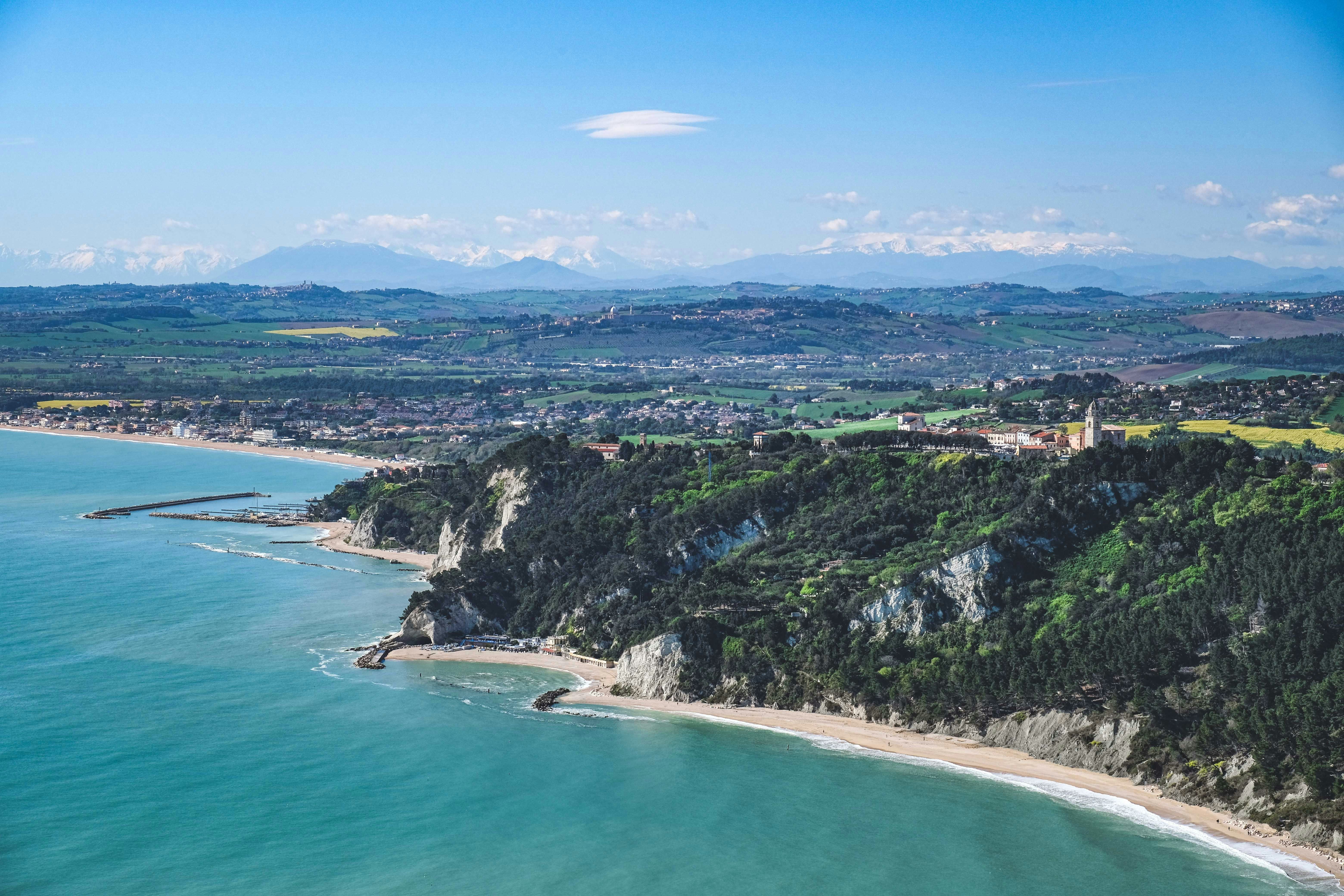 sandy coastline in Ancona with green hills behind