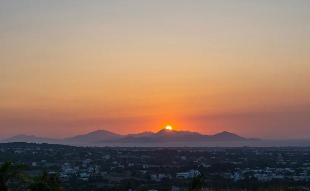 Puesta de sol sobre la isla de Kos con montañas al fondo