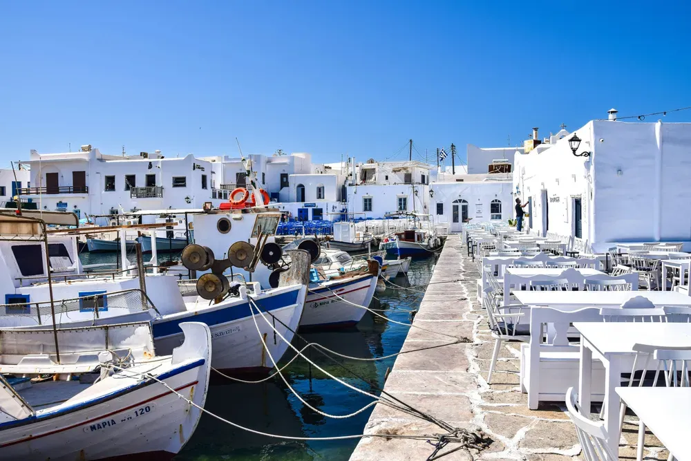 boats docked alongside restaurants in Paros