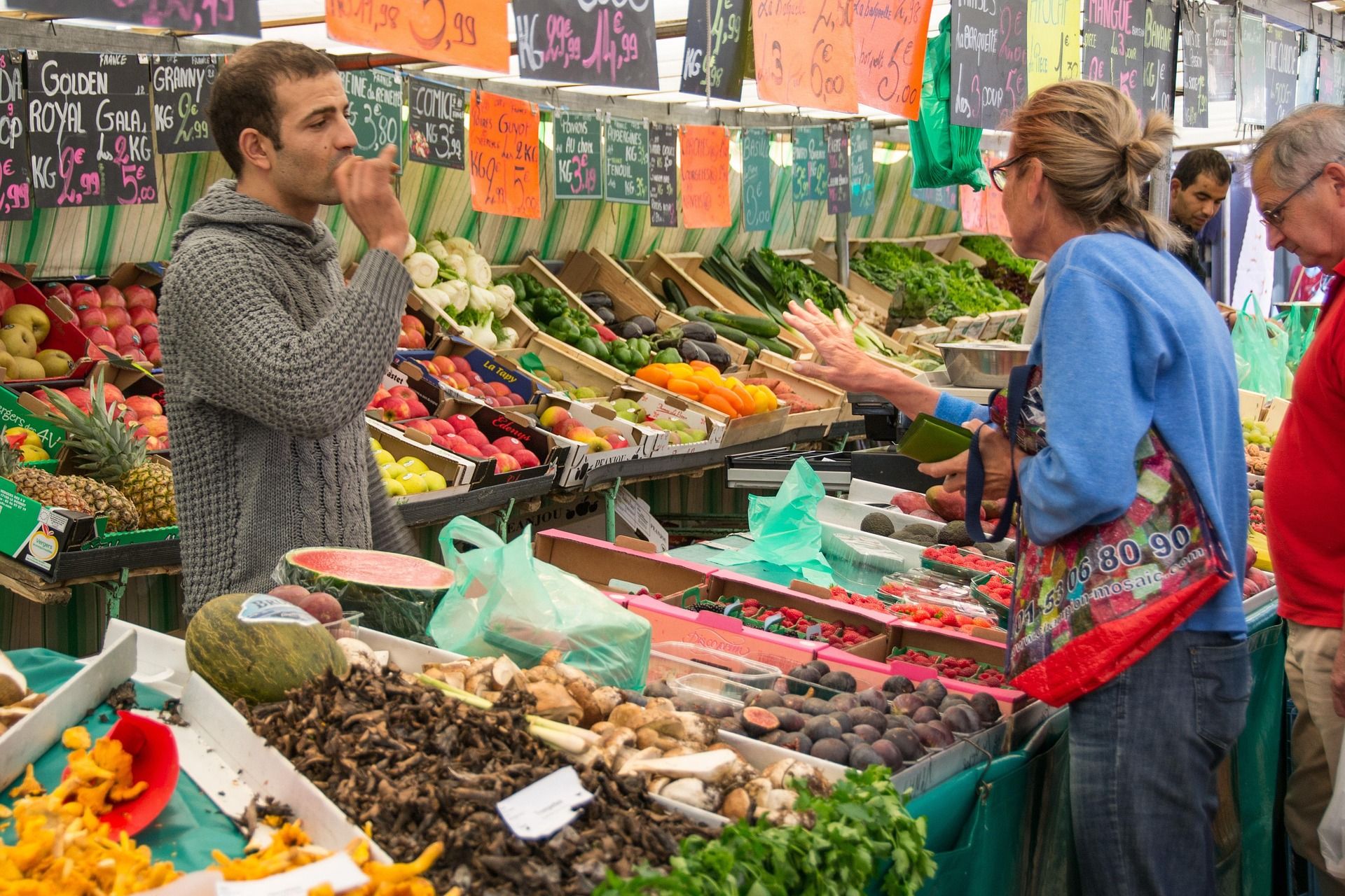 a vendor selling fruit at an outdoor stall
