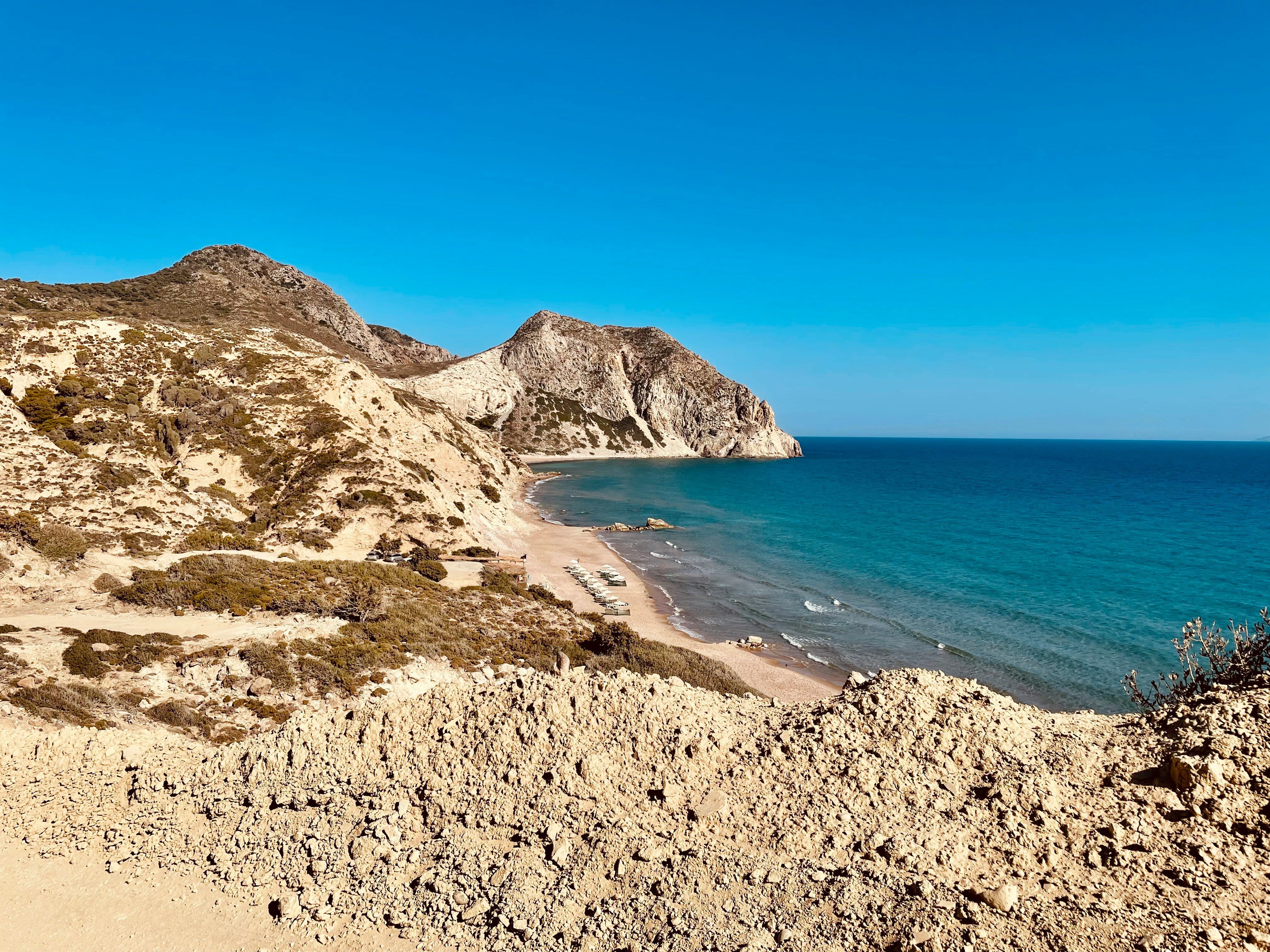 sandy bay surrounded by cliffs in Kos