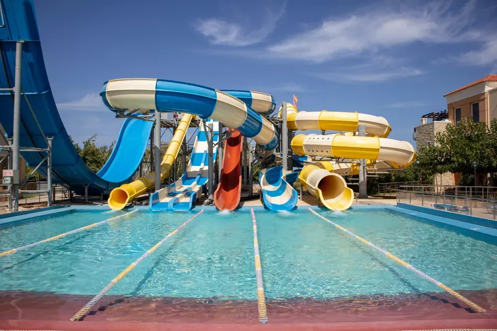 colourful waterslides leading into a swimming pool.webp
