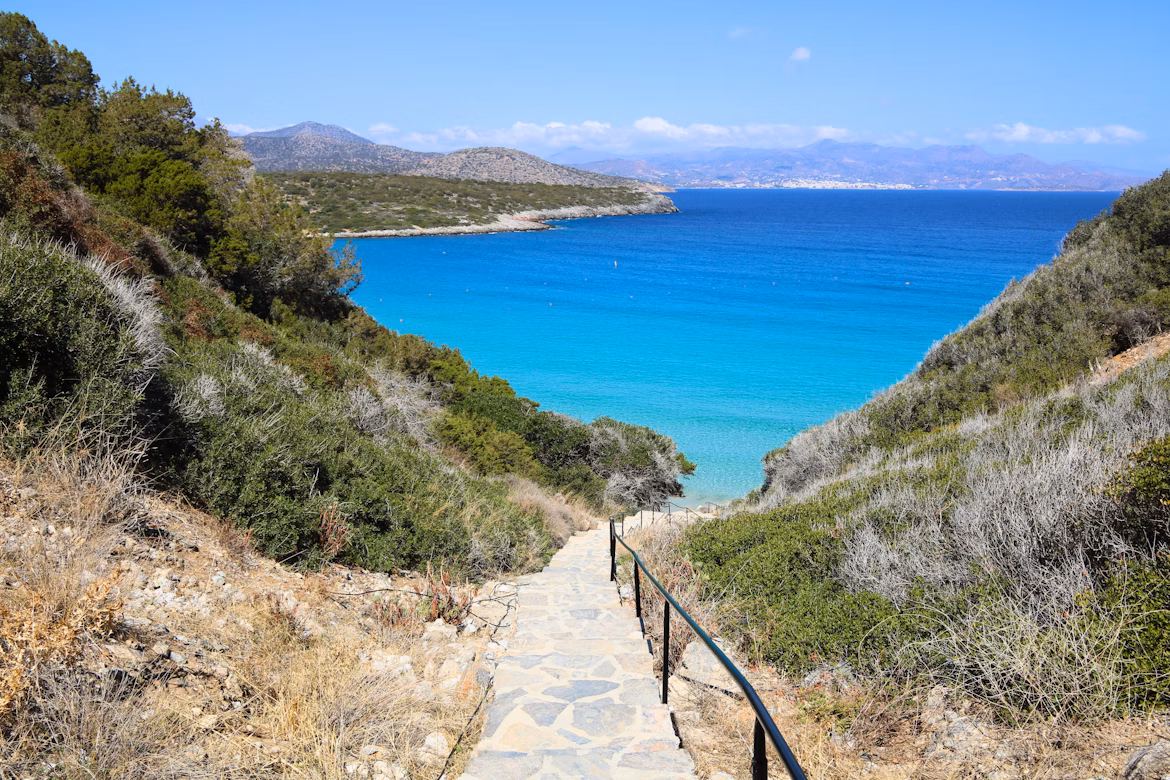 stairway leading to a secluded cove with blue water