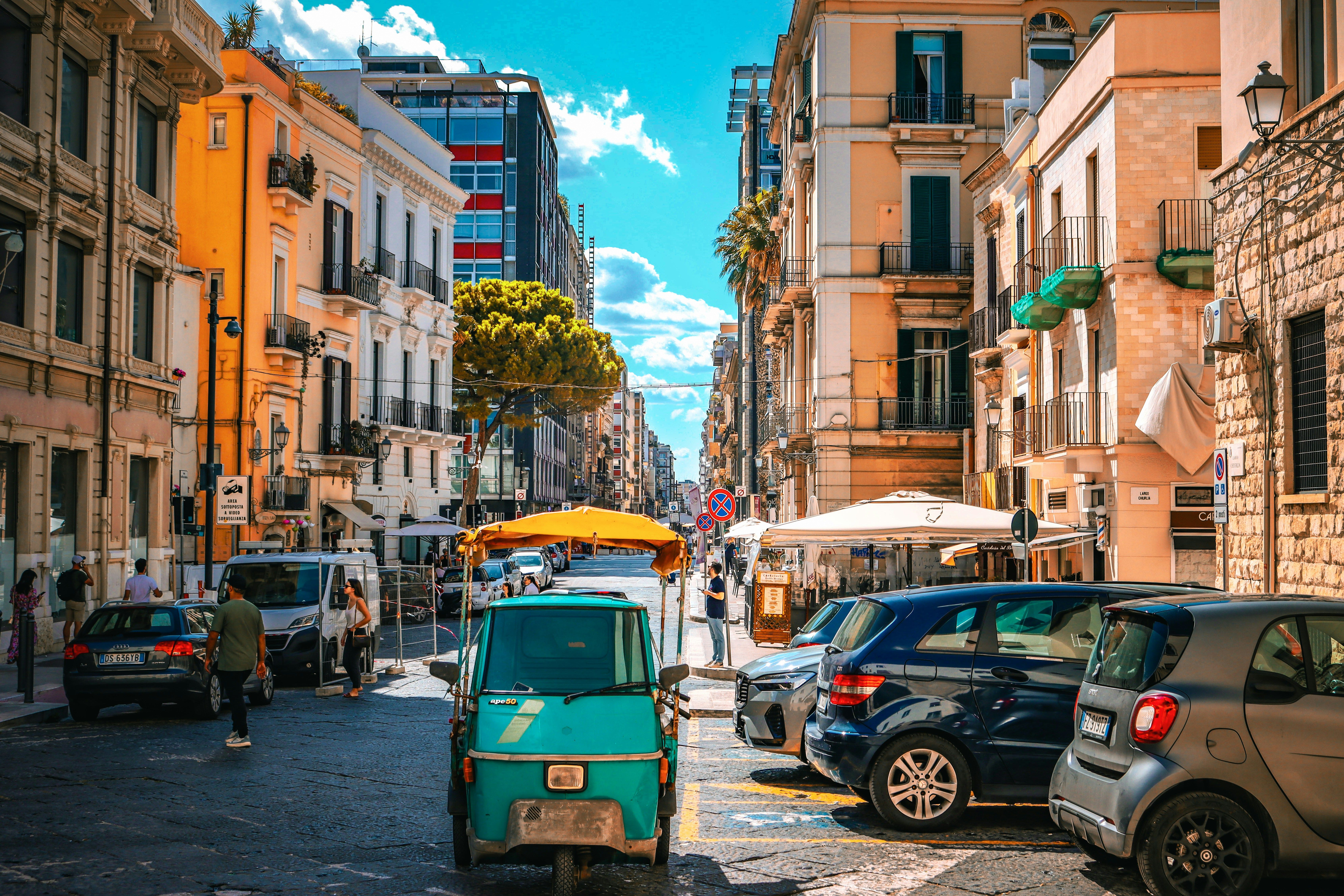 cars parked in busy street in Bari