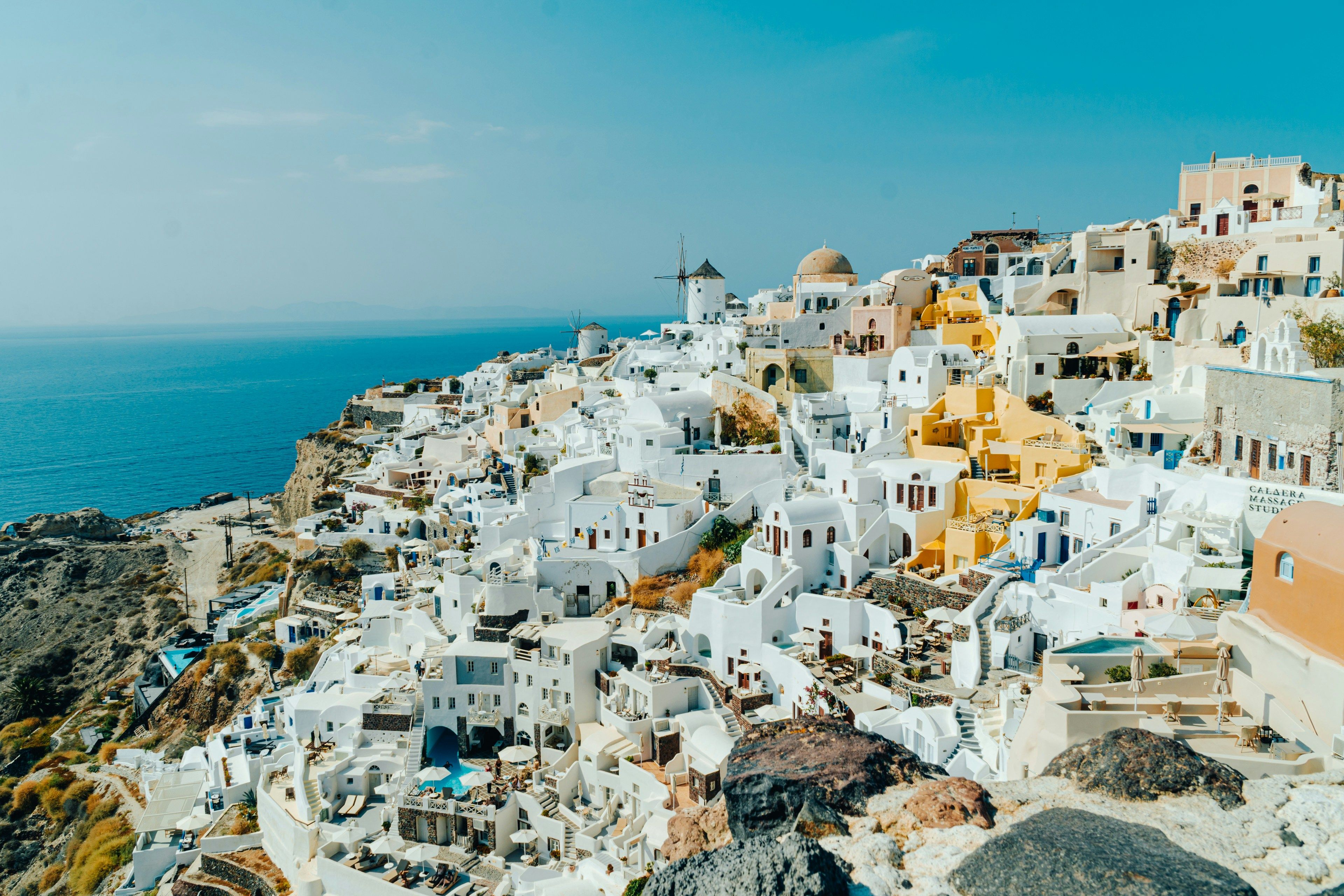 white buildings on a cliff next to the sea