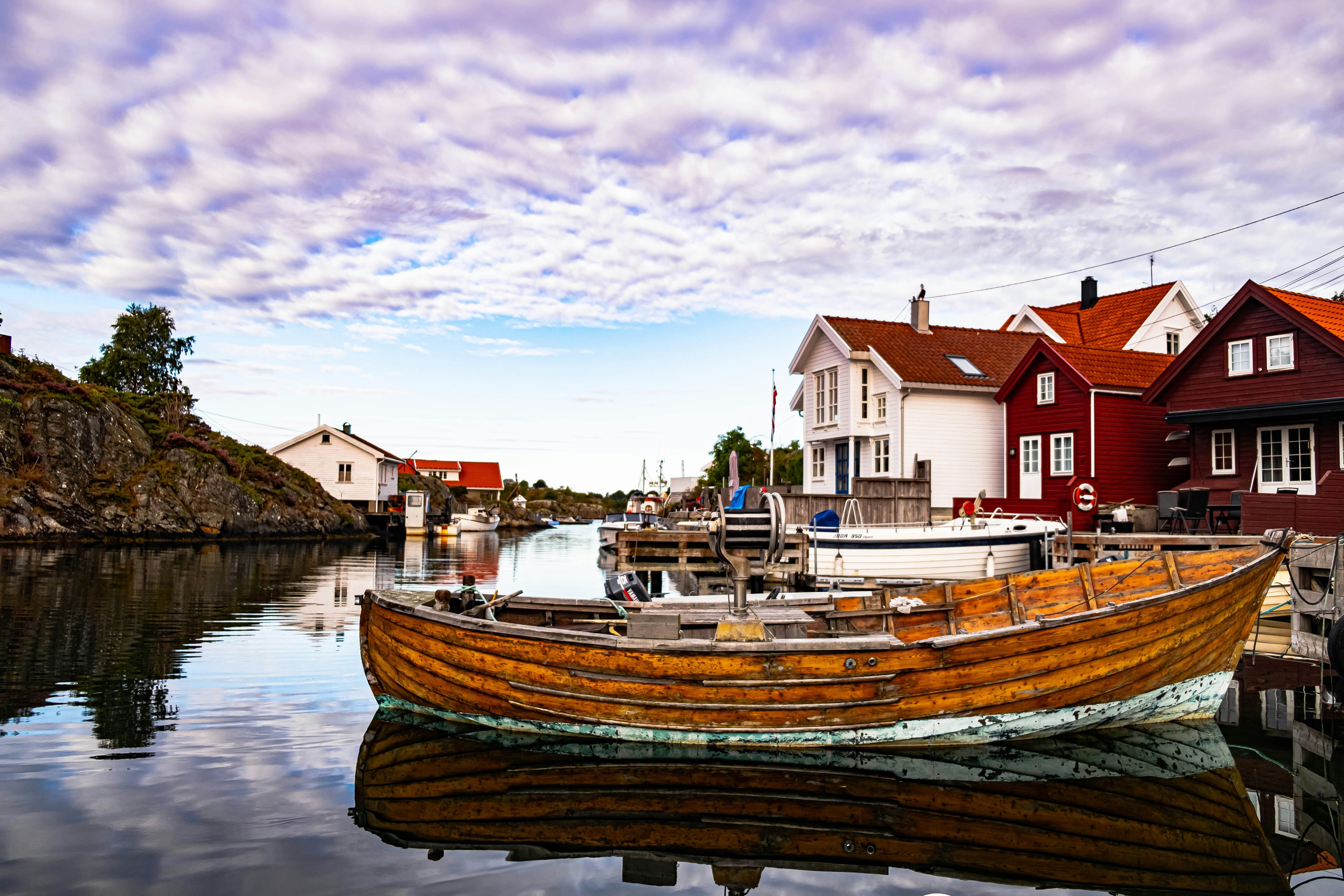 boat docked by houses in Kristiansand