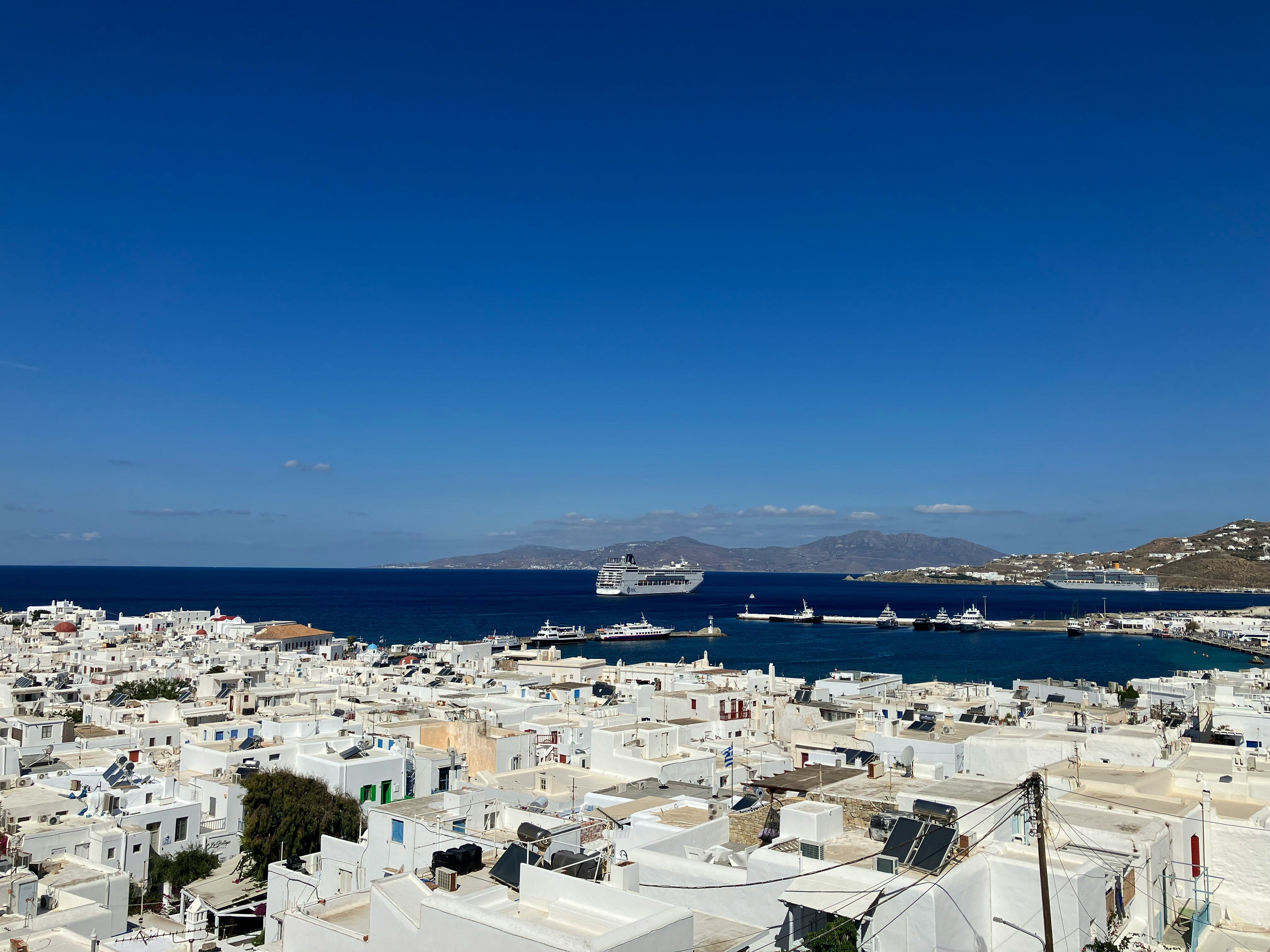 ferry in the sea with white buildings in front