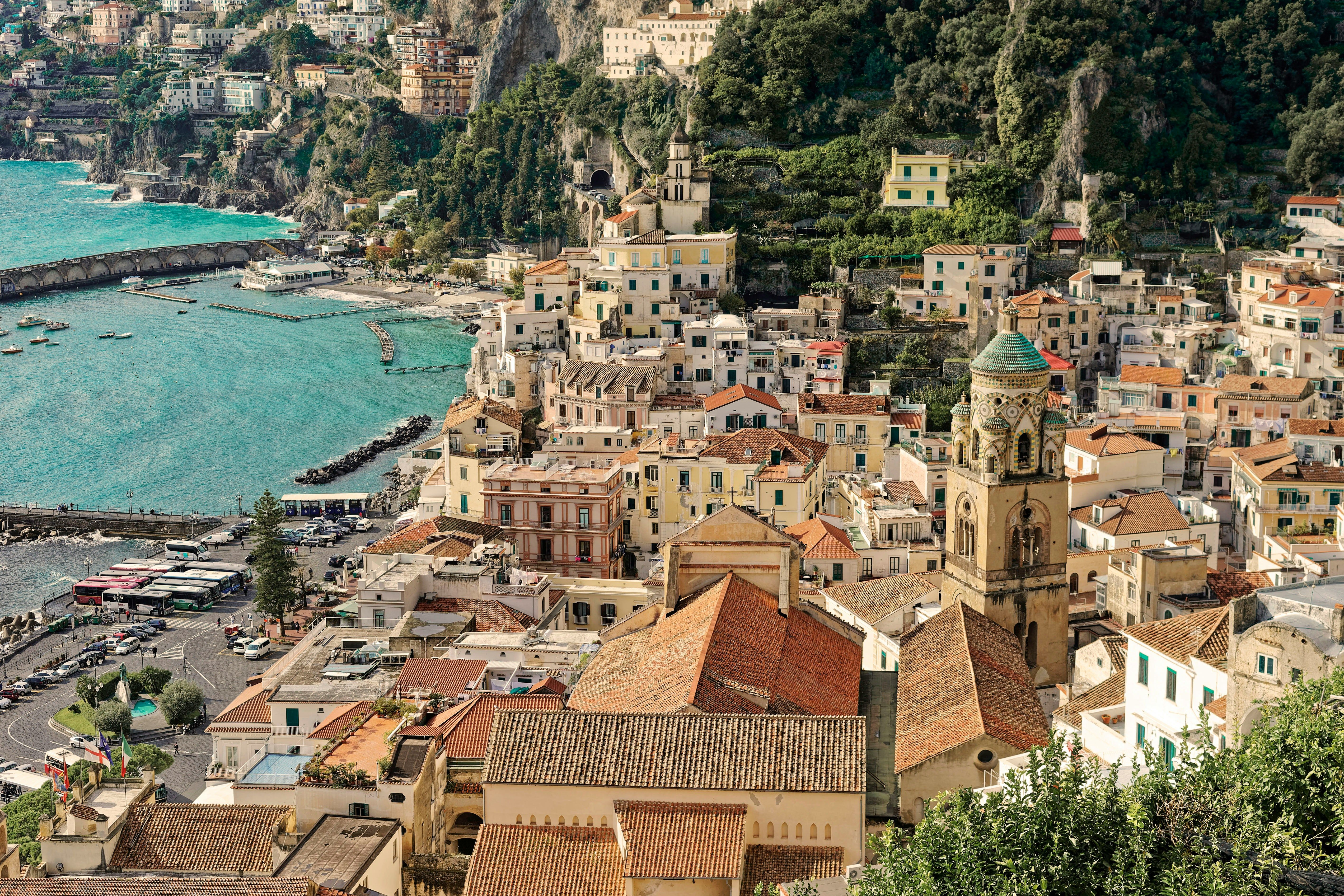 brown rooftops of Amalfi town next to the sea