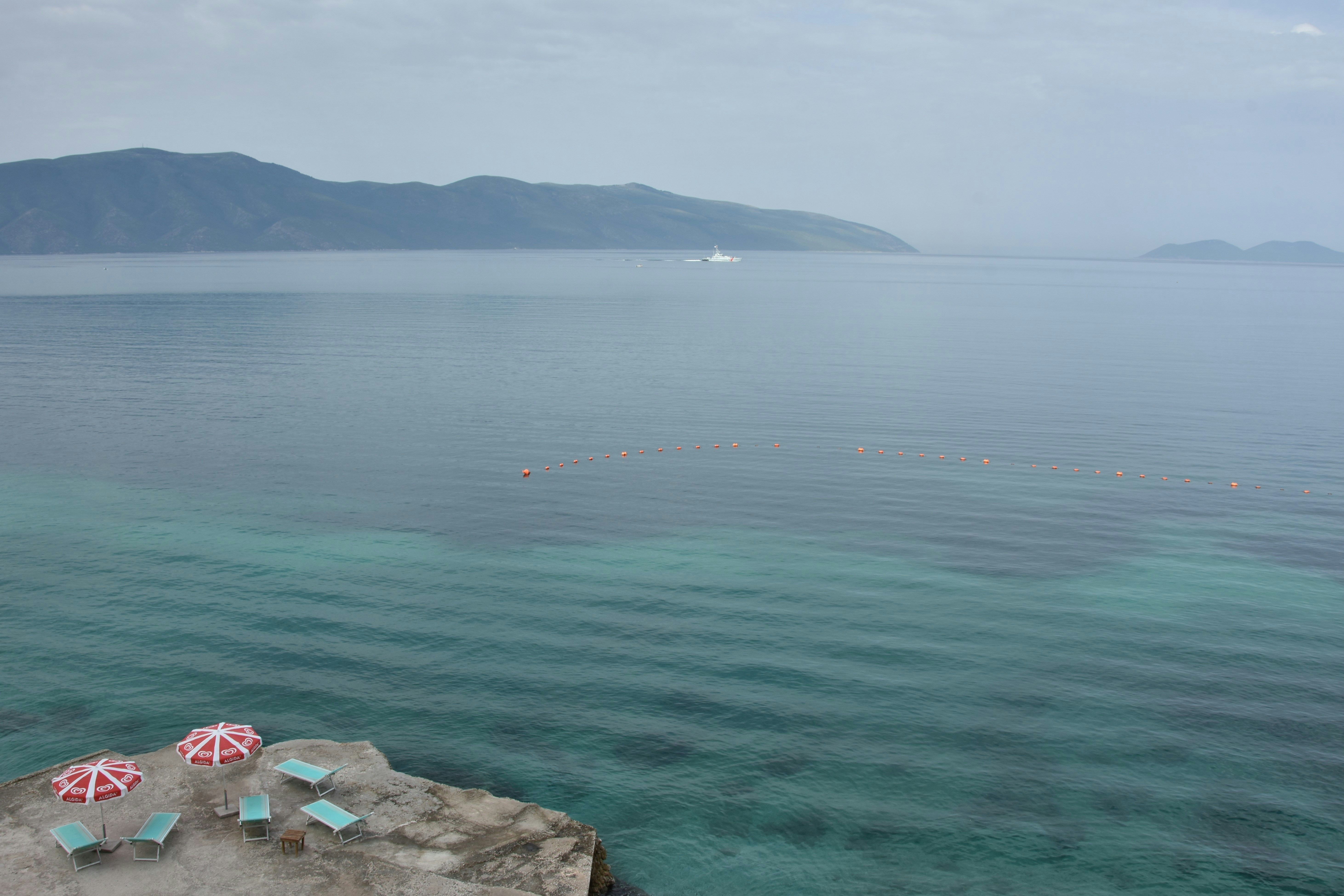 sun loungers on a cliff next to the sea