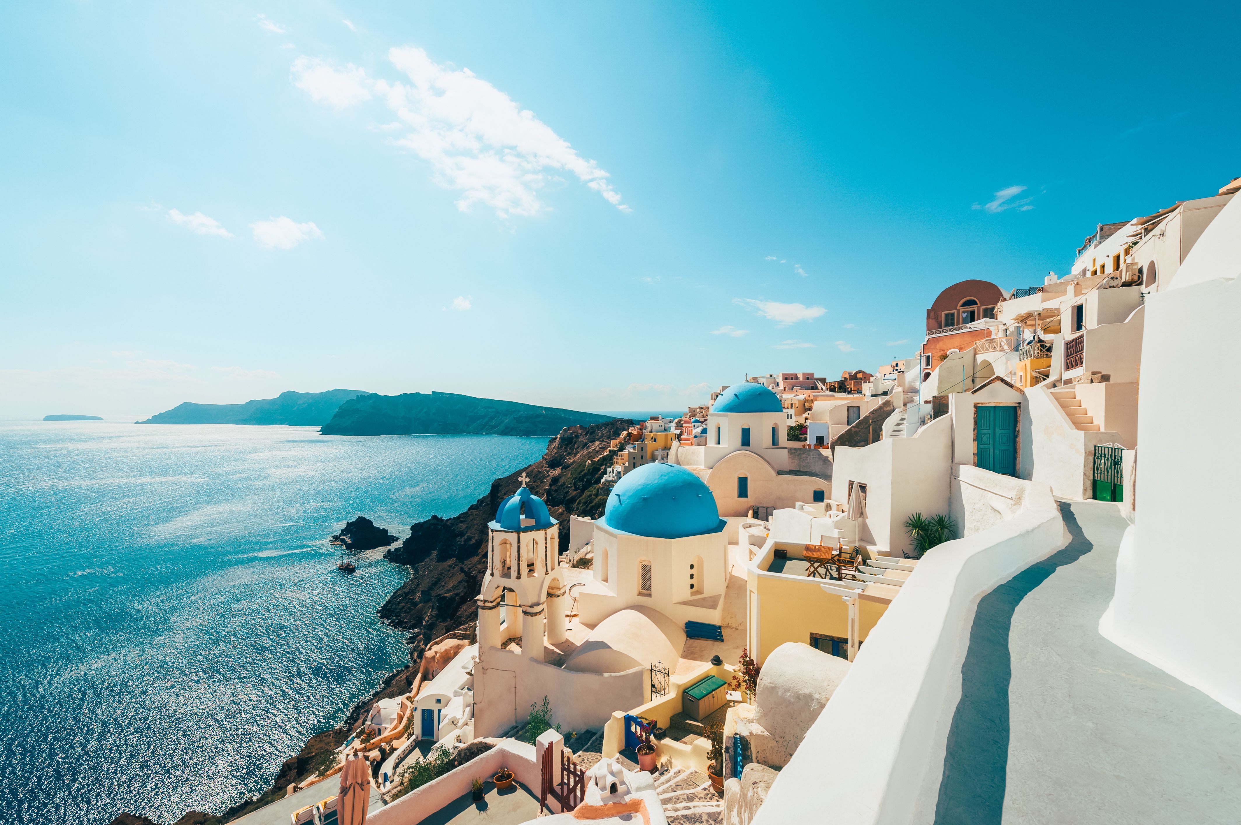 white buildings on the cliffside next to the sea