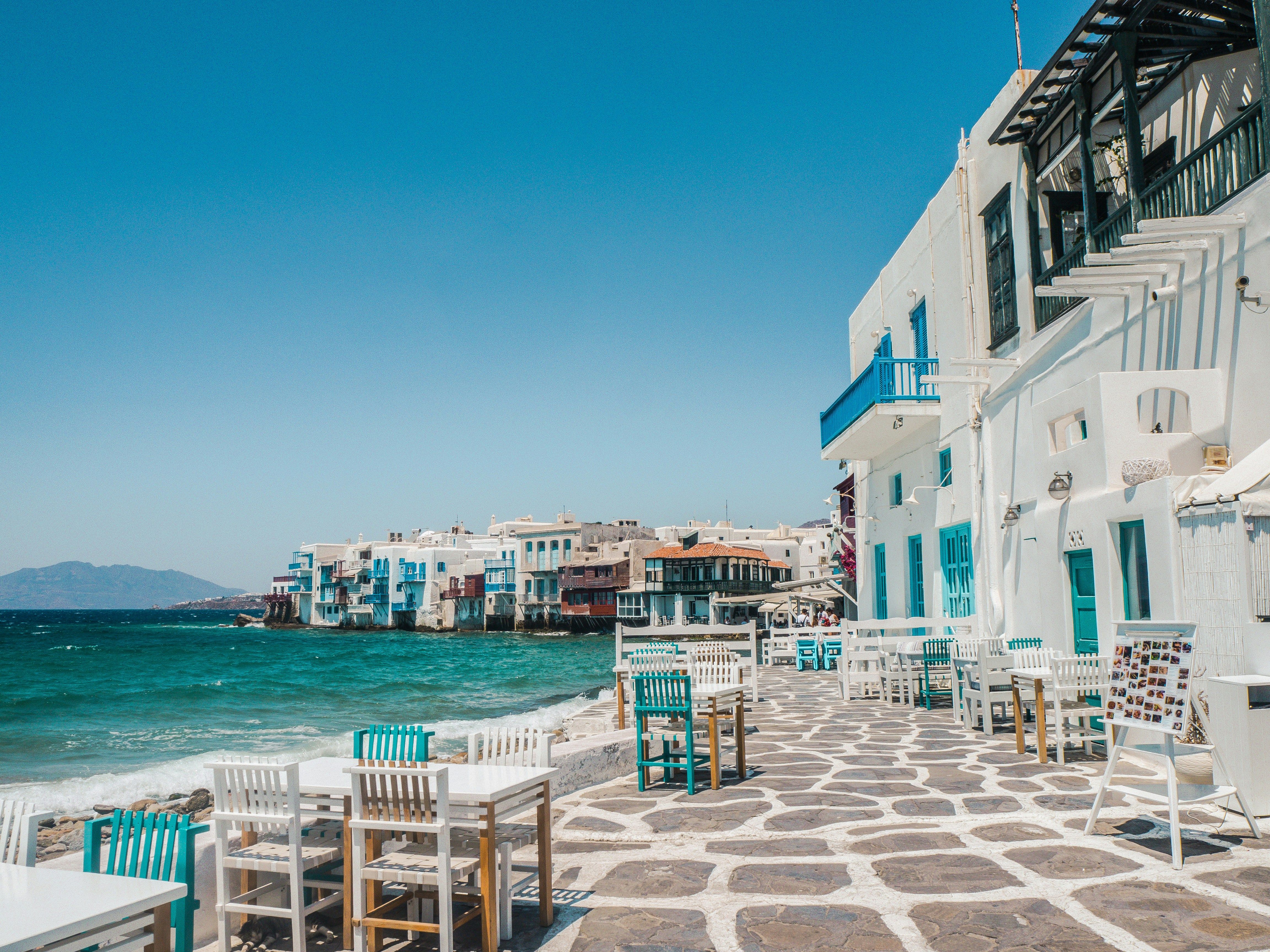 blue and white buildings and tables by the sea in Little Venice