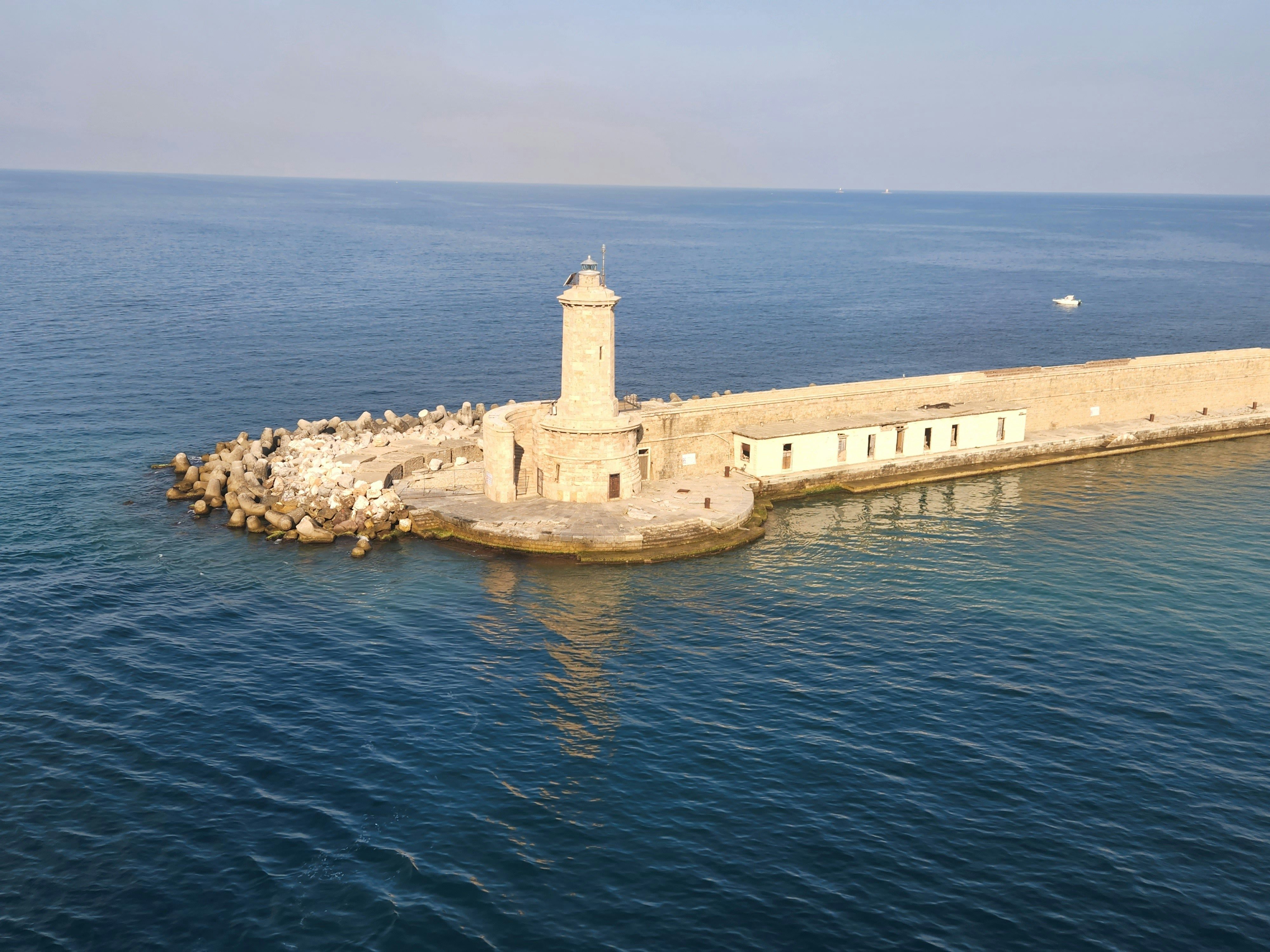 lighthouse jutting out into the sea
