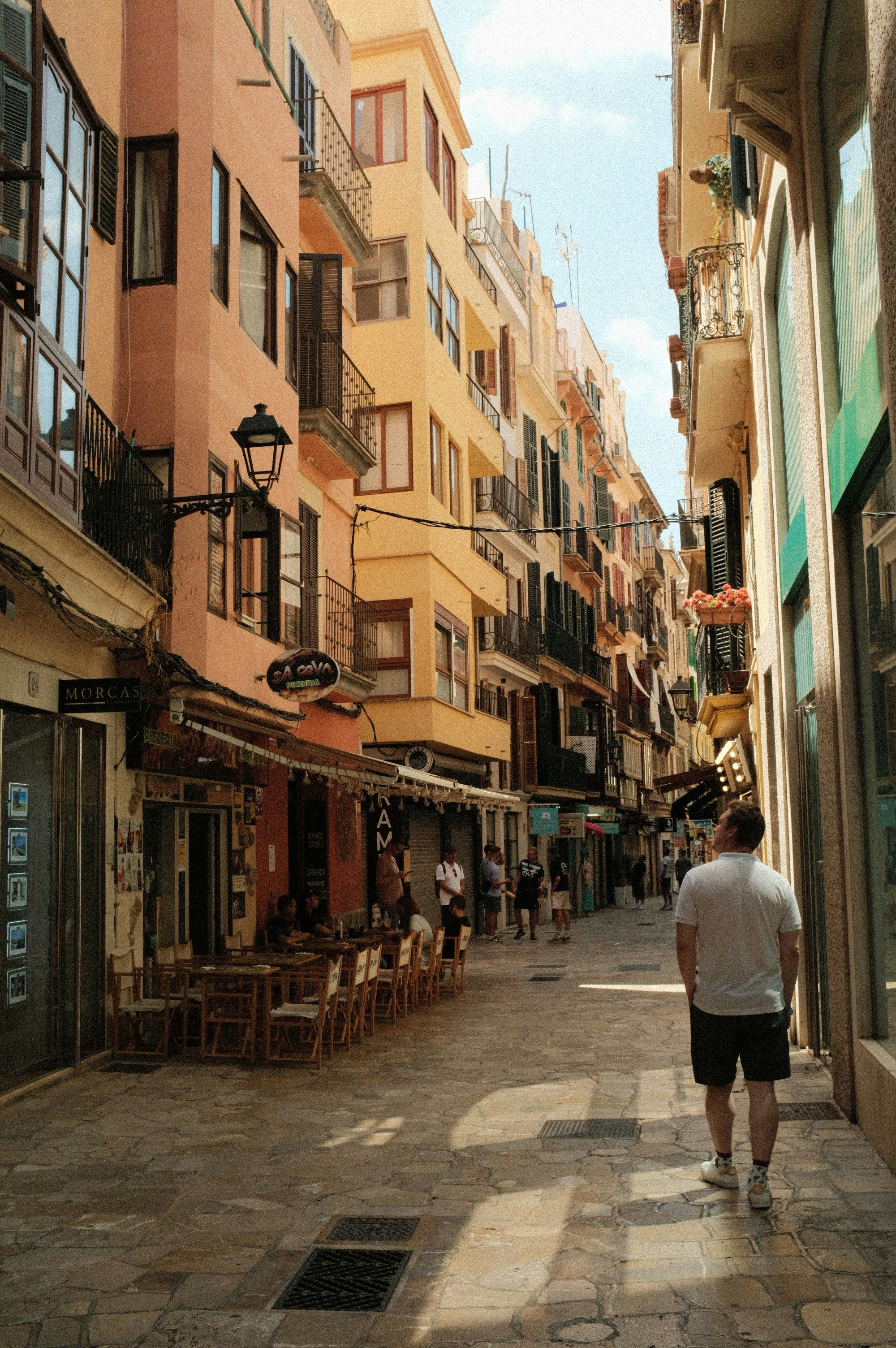 man walking down a narrow street in Palma