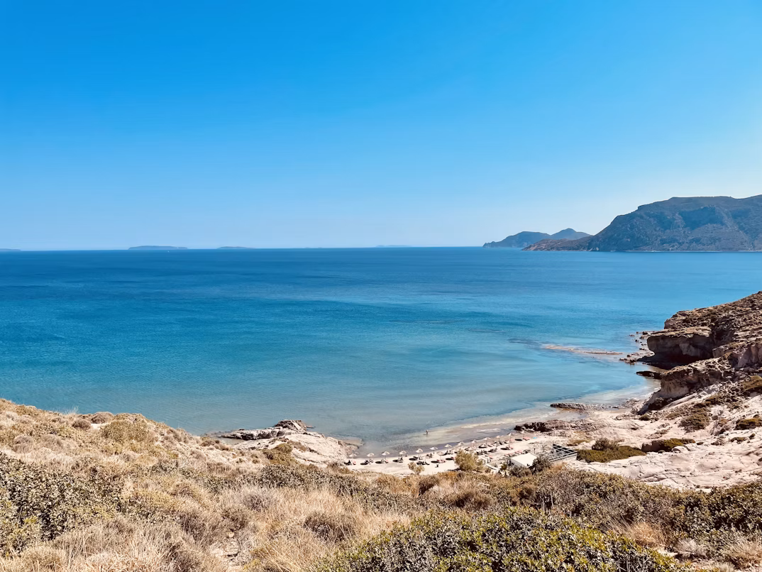 a sandy beach in Kos with a blue sky