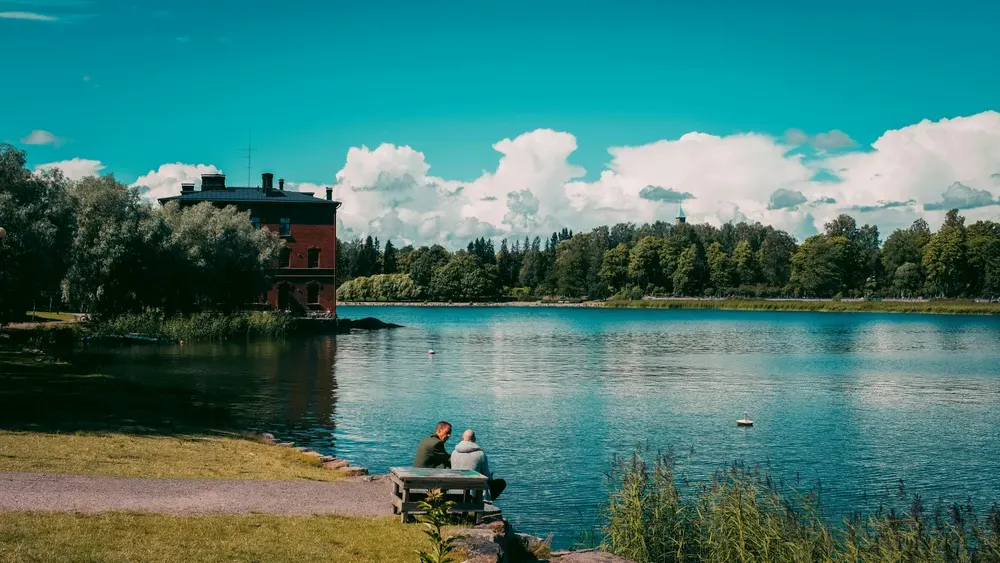 people sat by a lake in Helsinki