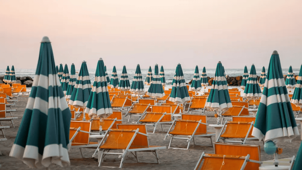 parasols et transats sur la plage avec ciel nuageux