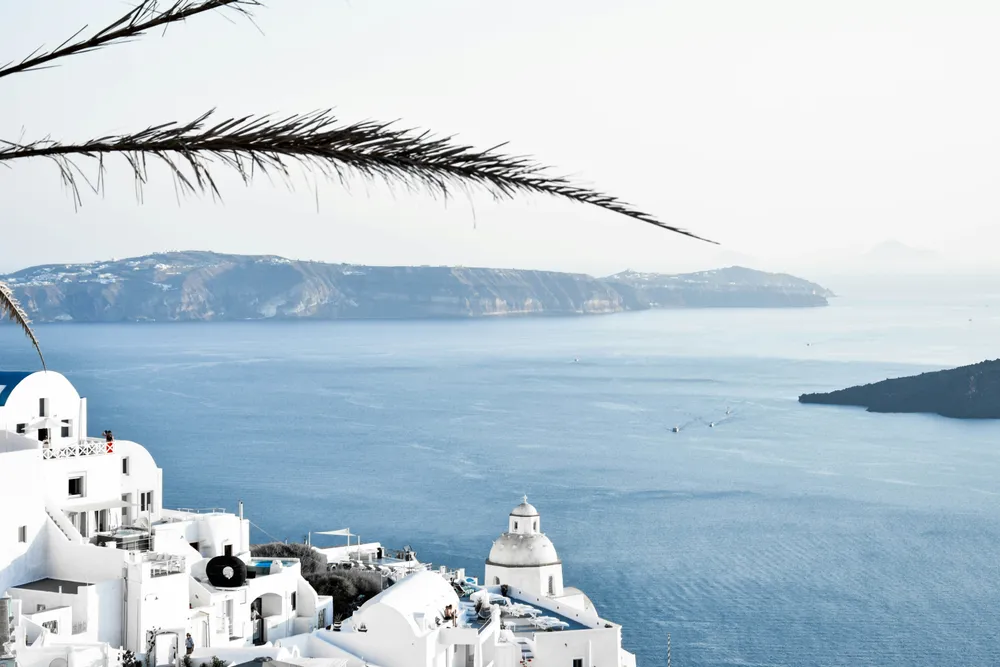 whitewashed buildings next to the sea in Santorini