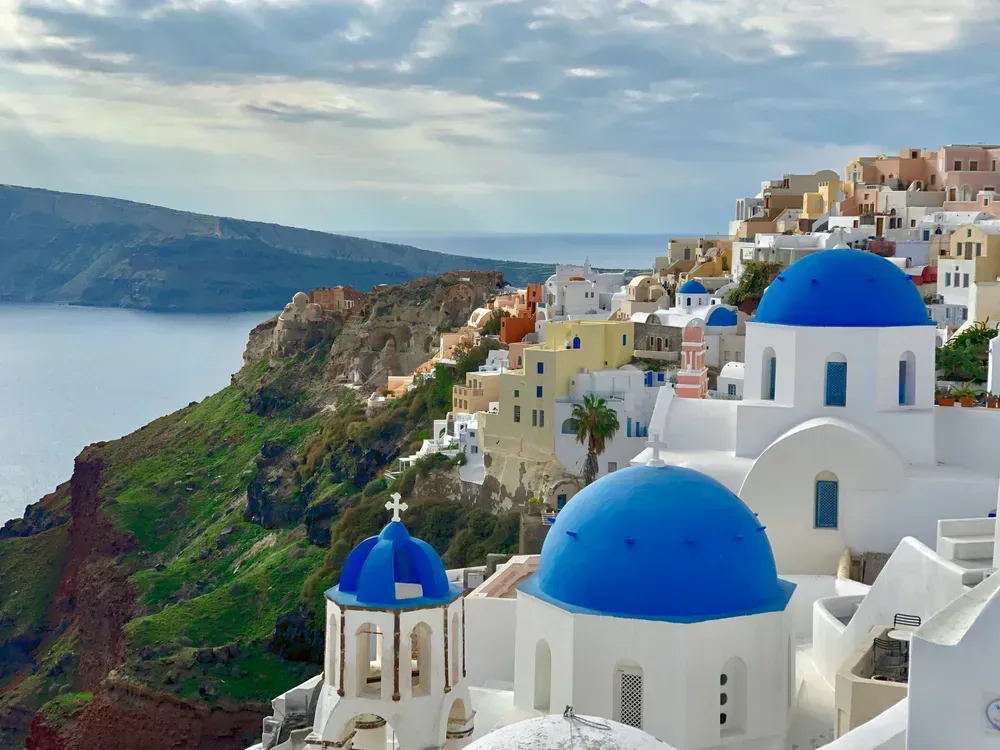 blue and white buildings on the cliffs in Santorini
