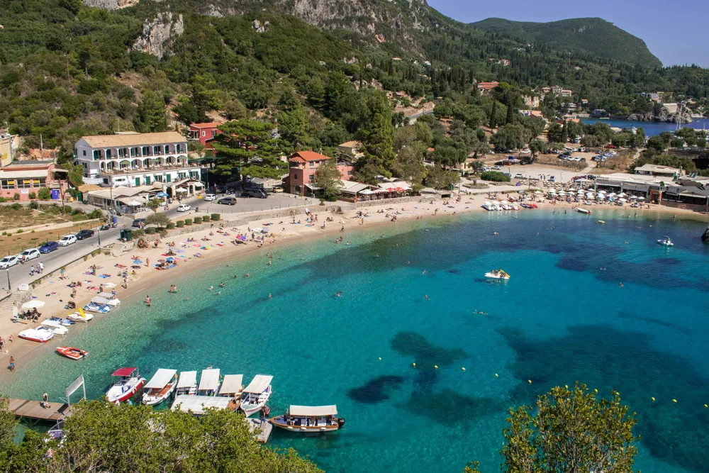 sandy beach in Corfu with green hills behind