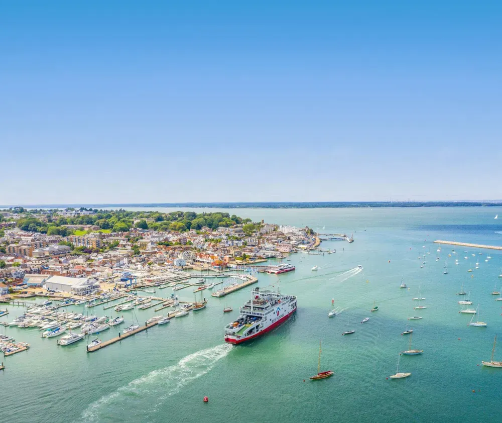 Red Funnel ferry sailing next to the Isle of Wight coast