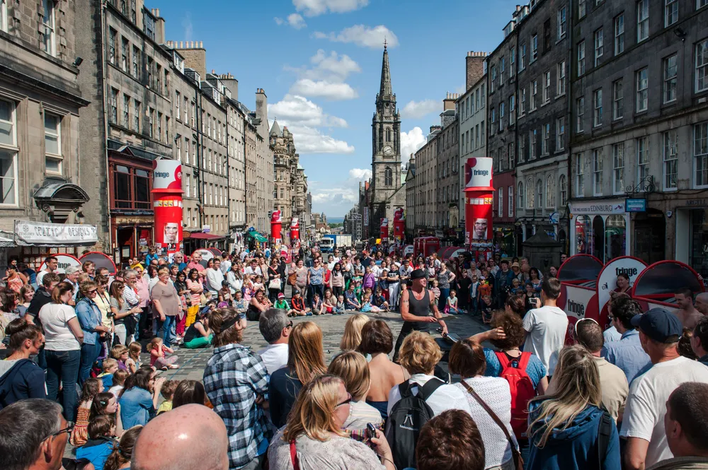 Crowds gathering to watch street performers on the Royal Mile during Edinburgh Fringe