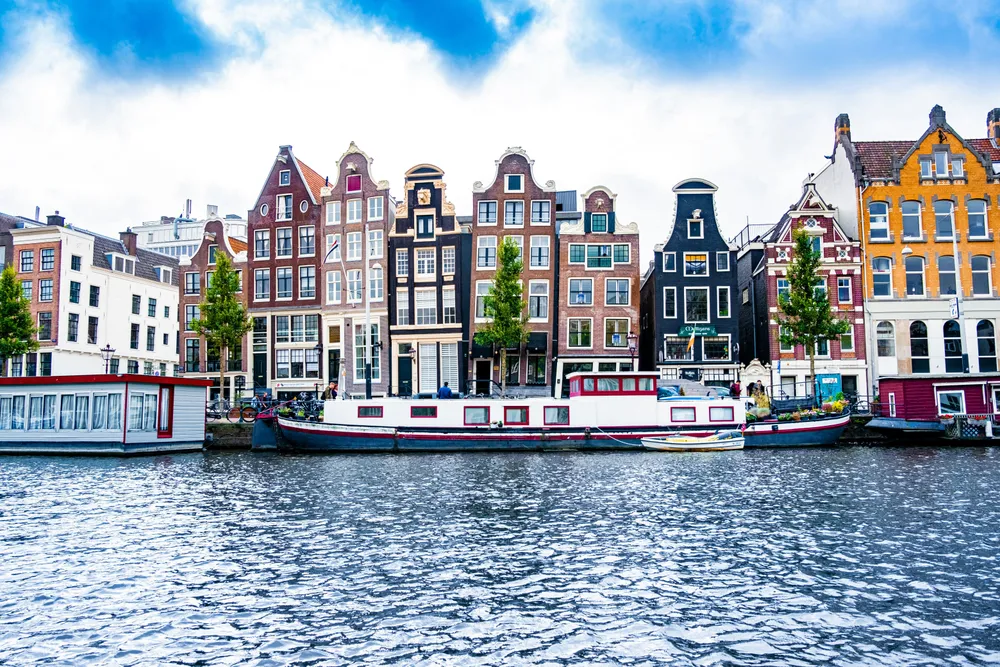 boat docked in front of a row of colourful houses