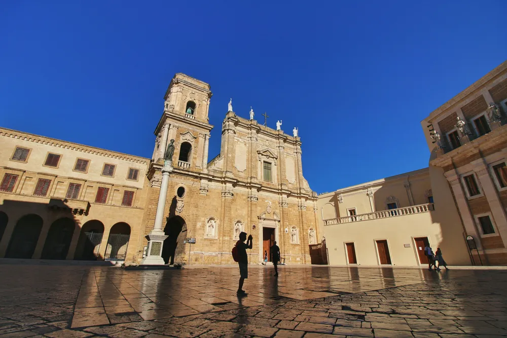 people standing in front of a grand building