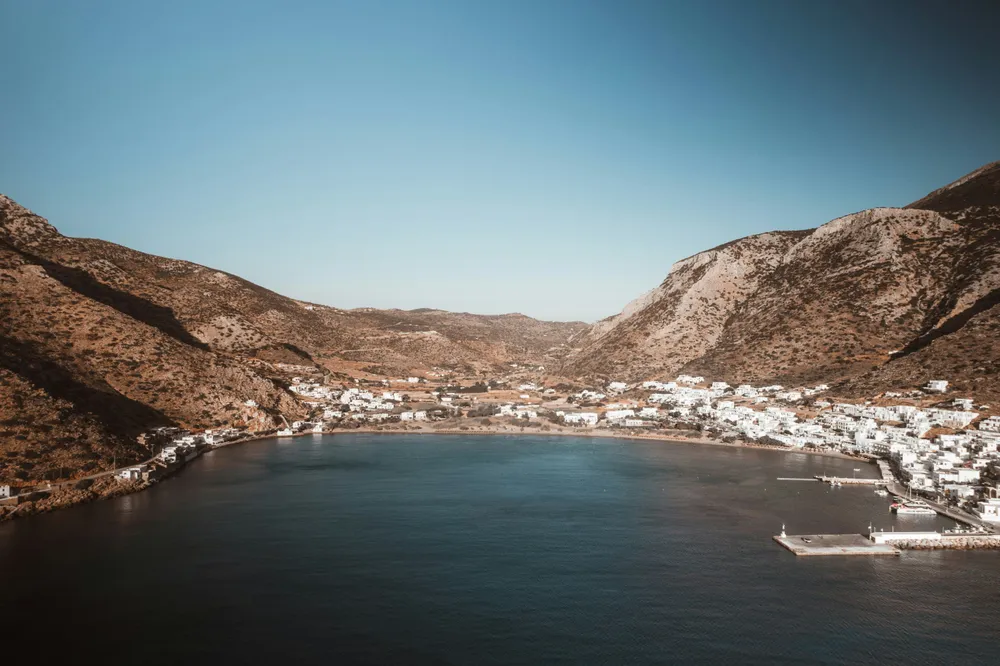 whitewashed town at the bottom of the mountains