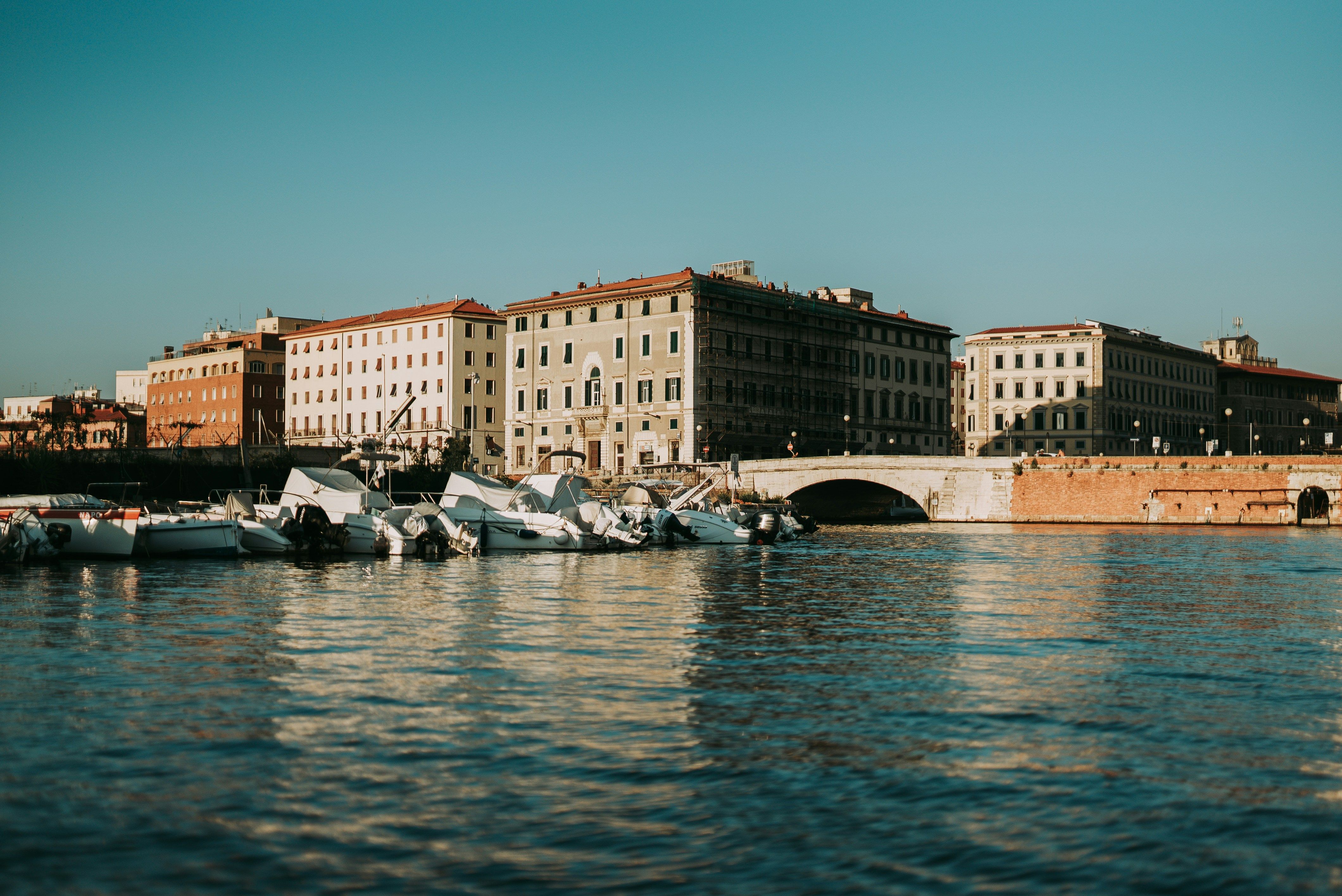 boats docked in the water next to buildings in Livorno