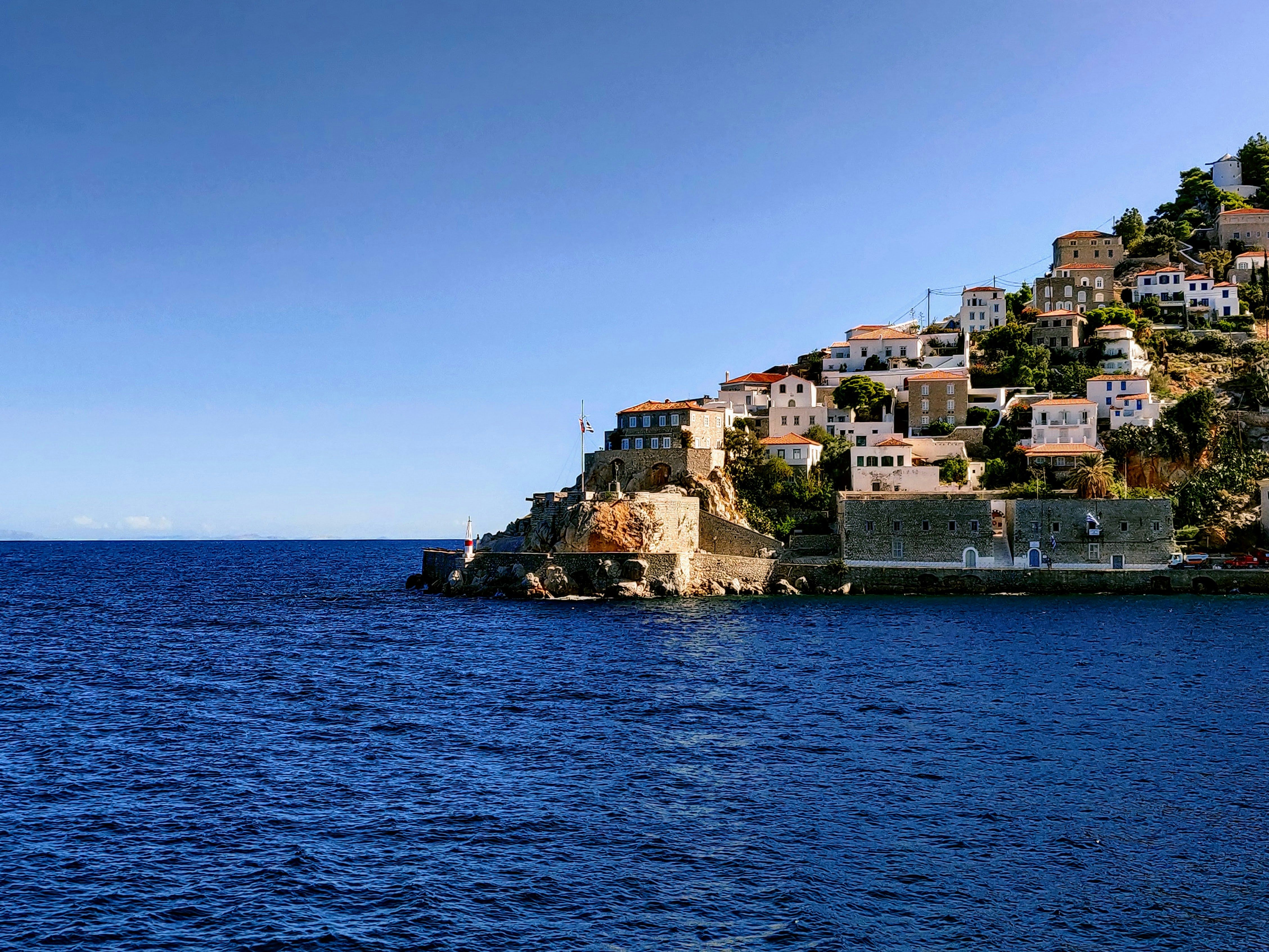buildings on a rock jutting out to sea