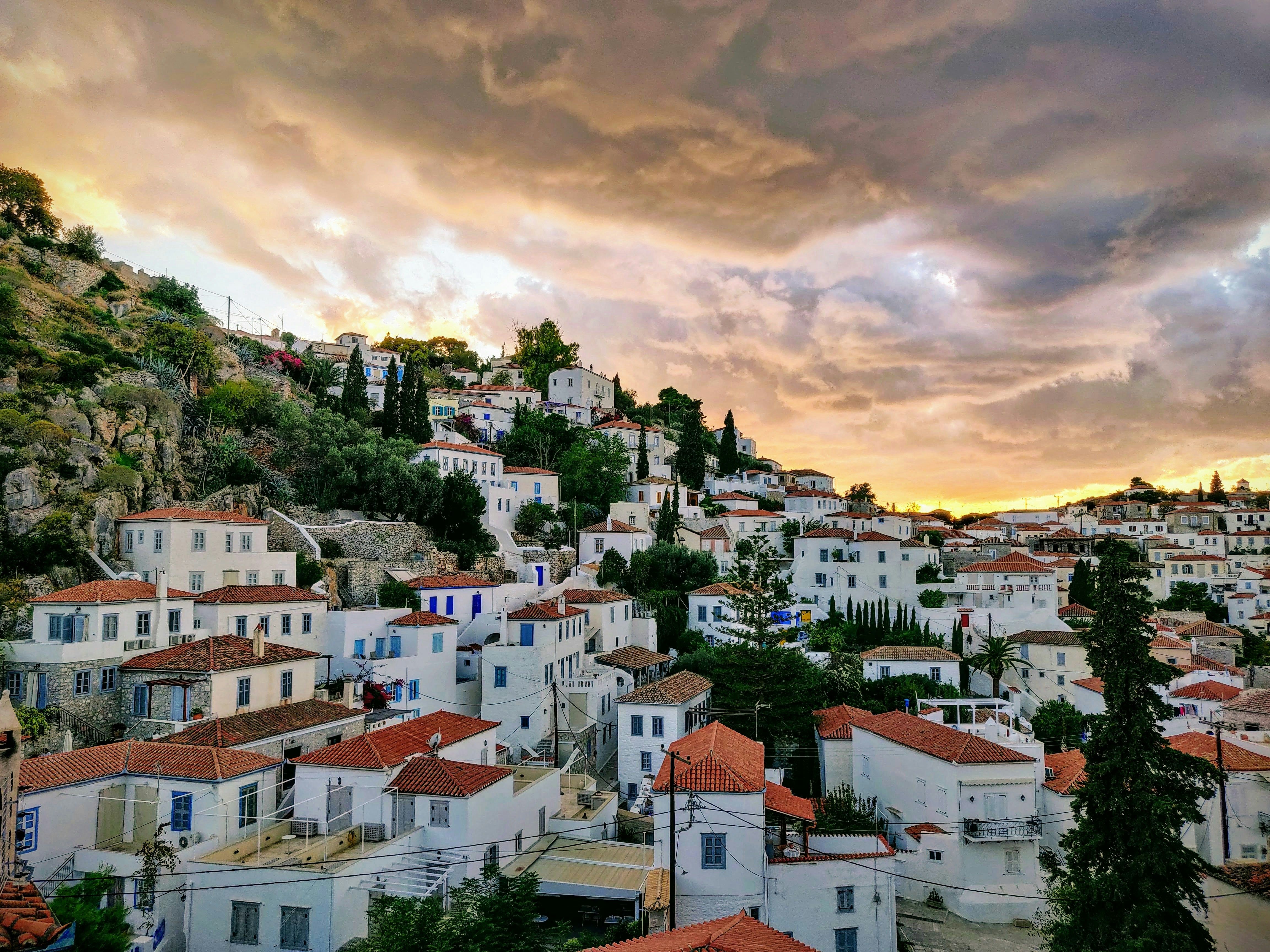 white buildings below cloudy skies