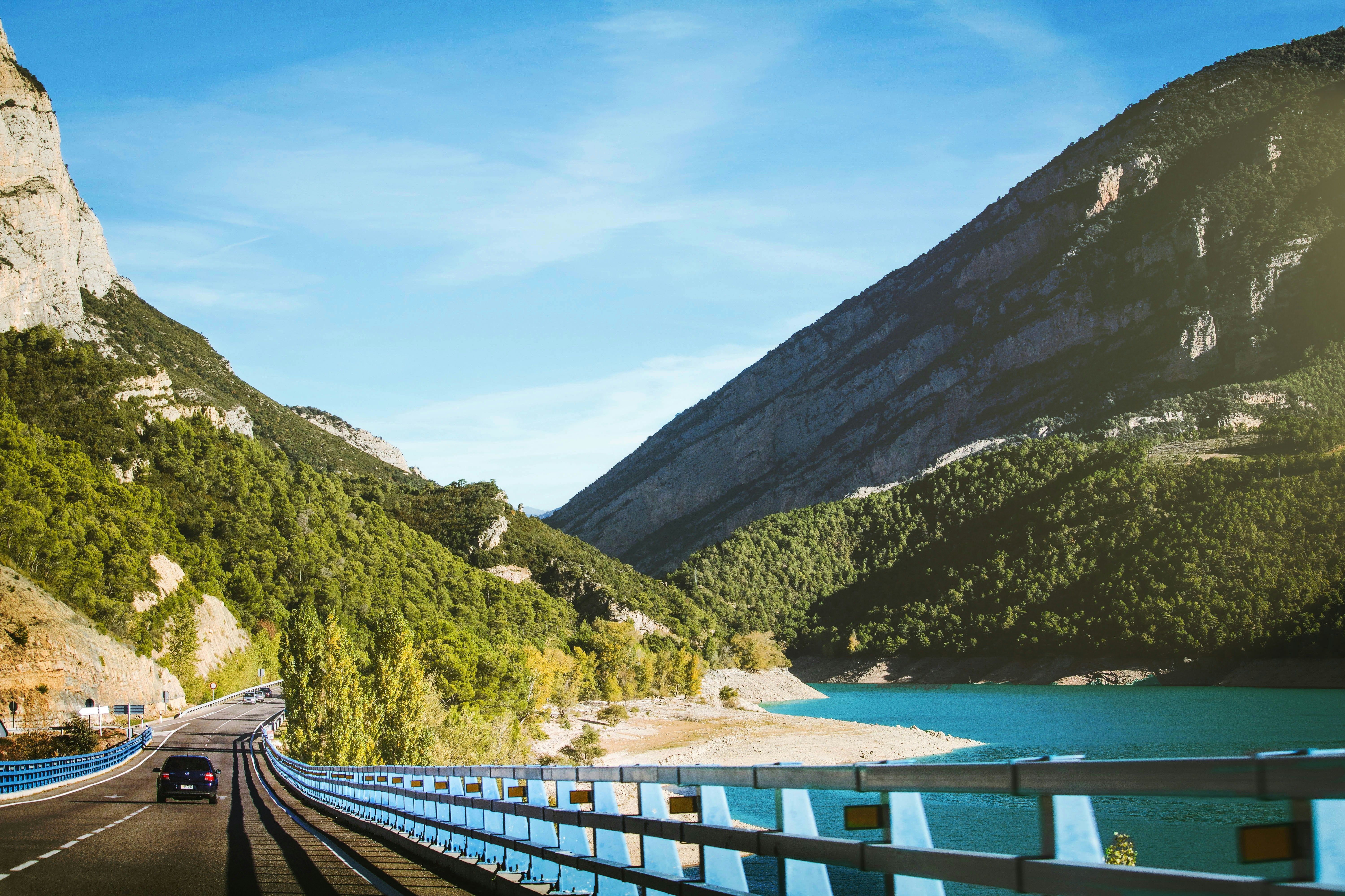 car driving through the mountains by the water