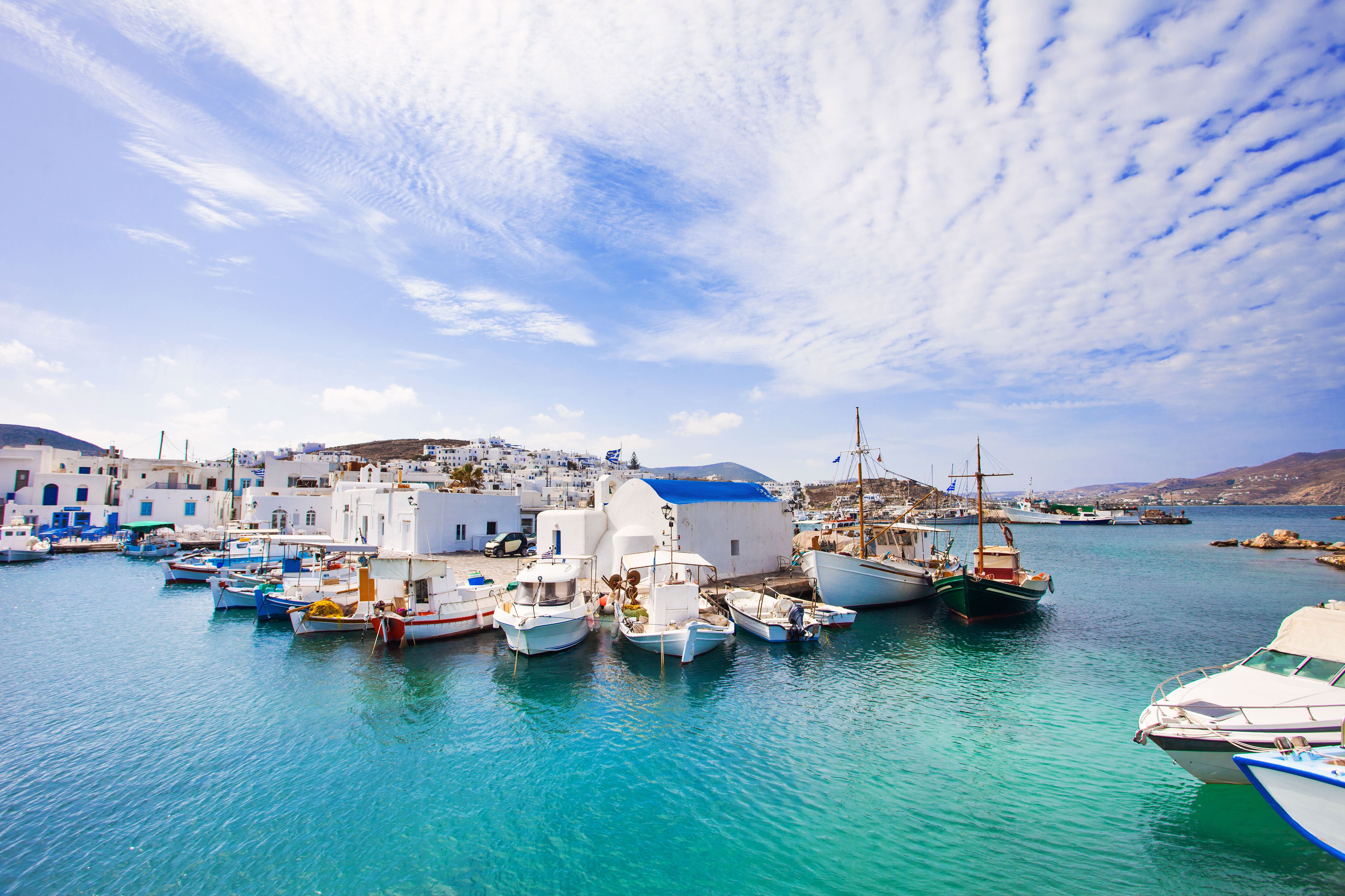 boats docked in the harbour in Paros